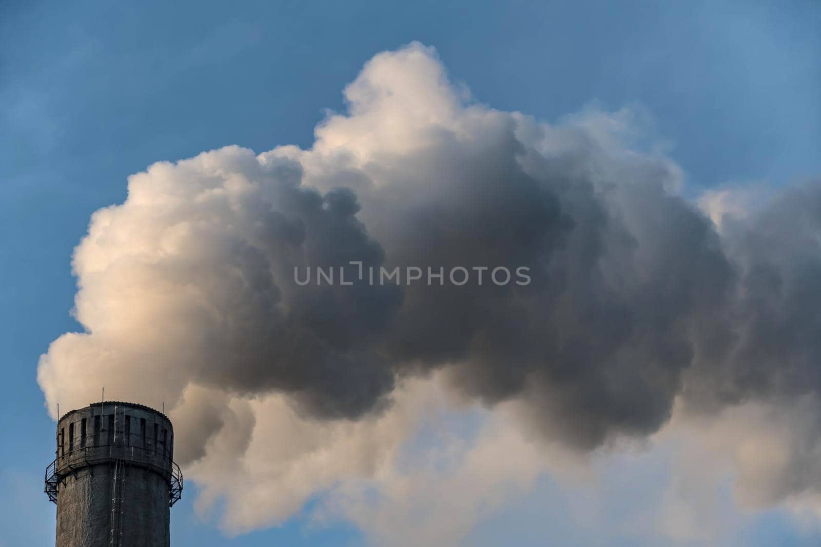 Smoking factory chimneys with co2 emissions.Environmental problem of environmental and air pollution.Climate change,ecology, global warming.The sky is smoky with toxic substances.Soot from factories by YevgeniySam