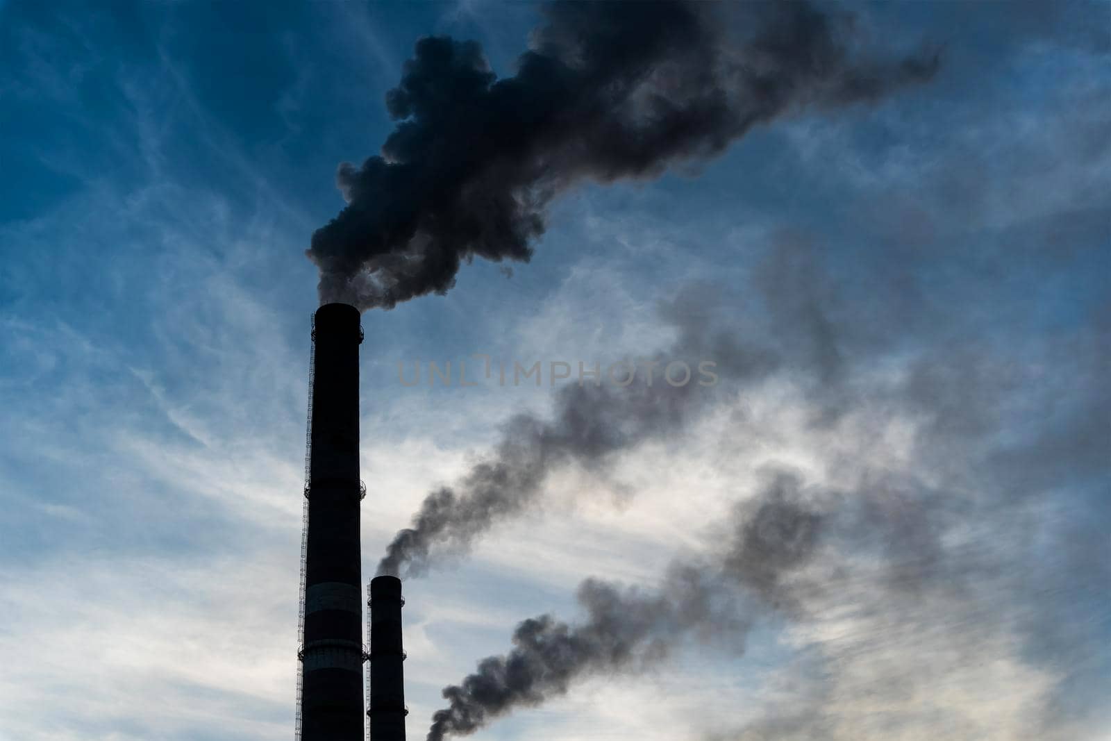 Smoking factory chimneys with co2 emissions.Environmental problem of environmental and air pollution.Climate change,ecology, global warming.The sky is smoky with toxic substances.Soot from factories by YevgeniySam