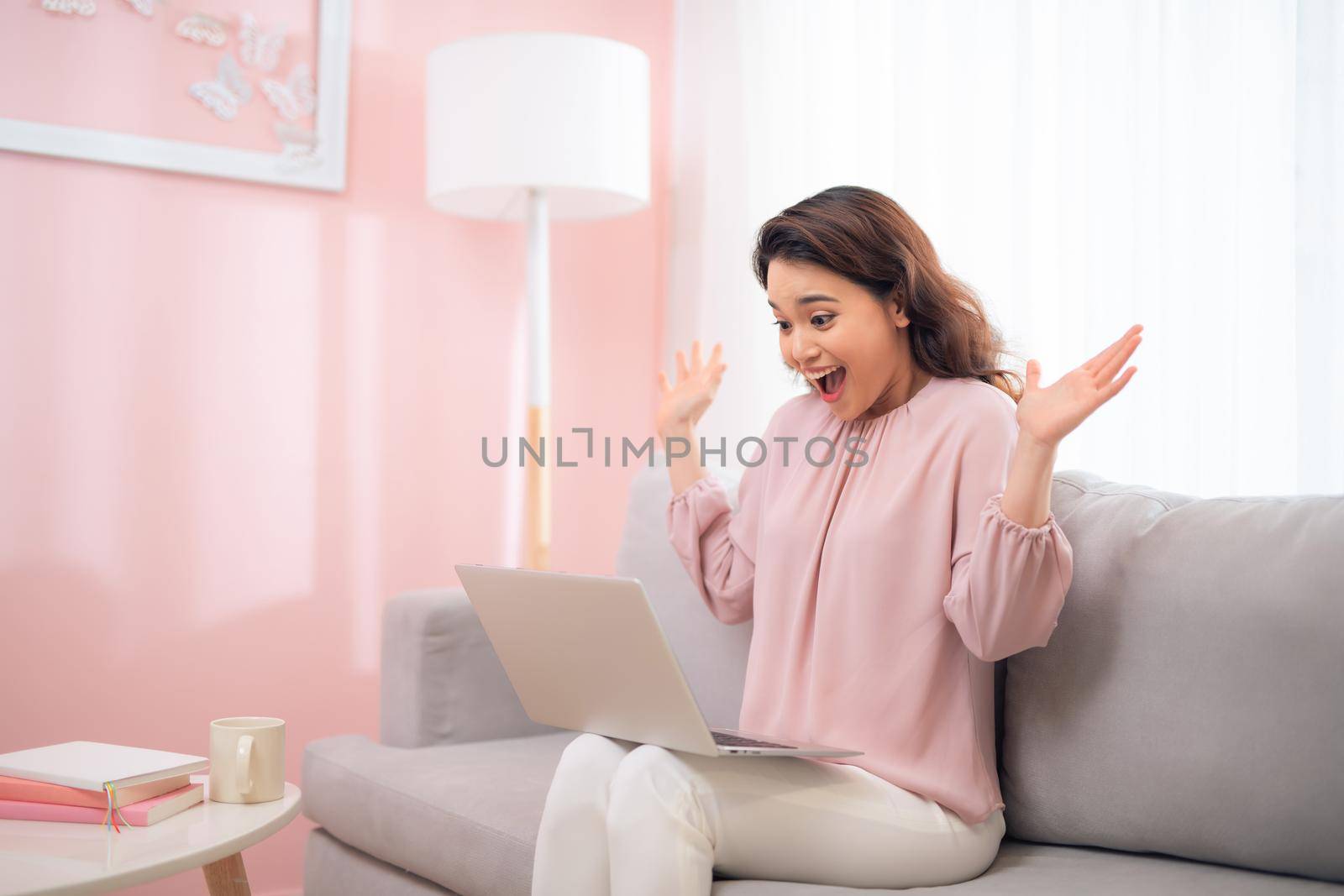 Excited young asian woman lifestyle image using laptop computer by makidotvn