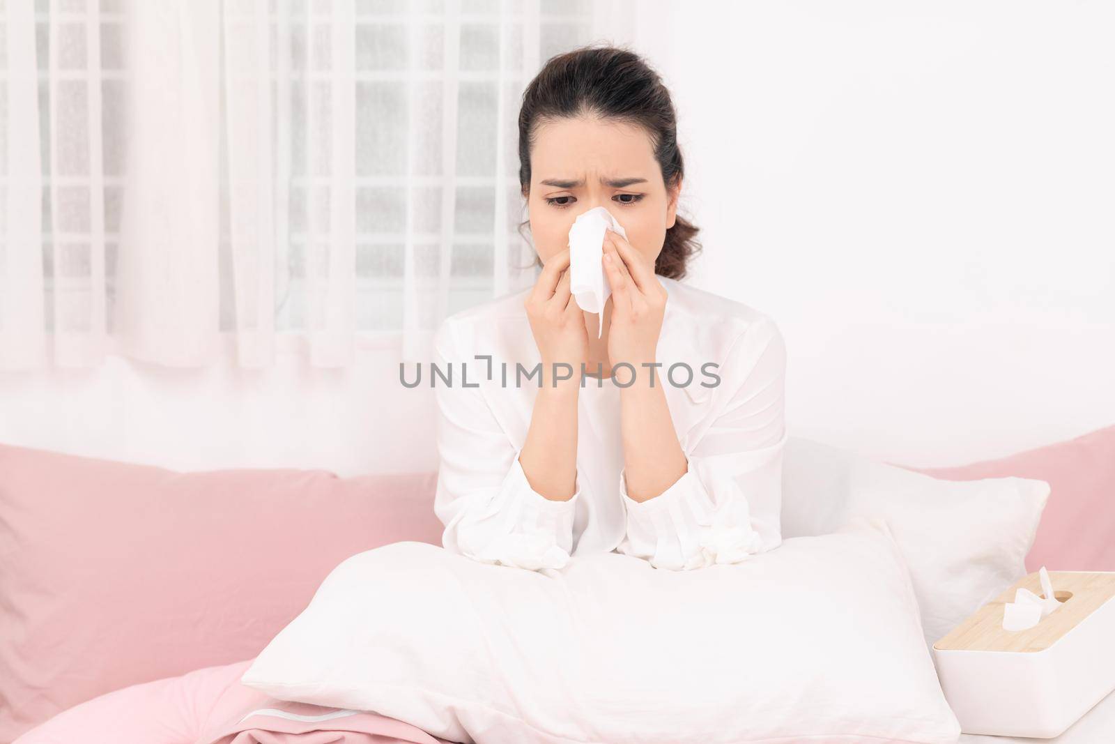 Sick woman with seasonal infections, flu, allergy lying in bed. 