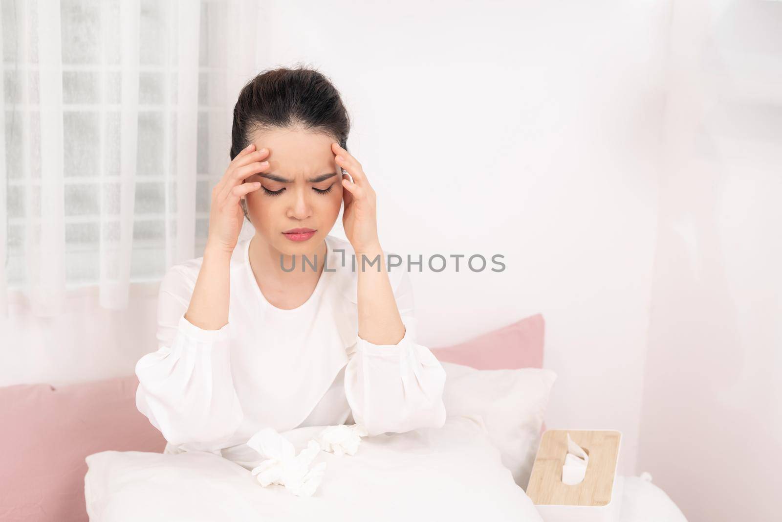 Young ill woman in bed at home