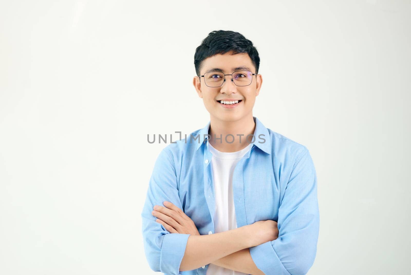 Attractive beautiful smiling positive nerd man. Close up portrait asian man wearing glasses isolated on white background.