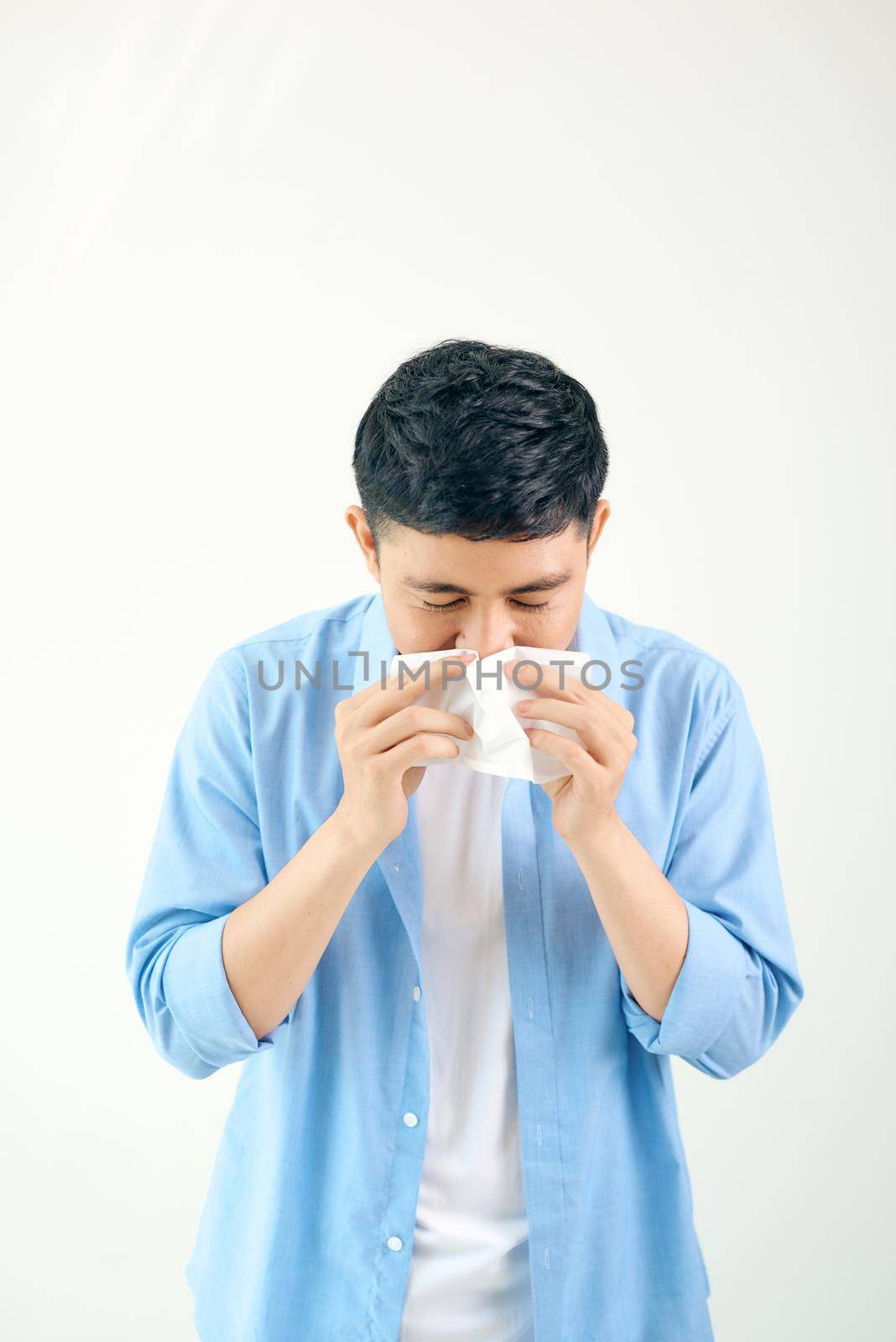 Sick young man handsome and sneeze isolated on white wall background. Concept of sick. Asia people. by makidotvn