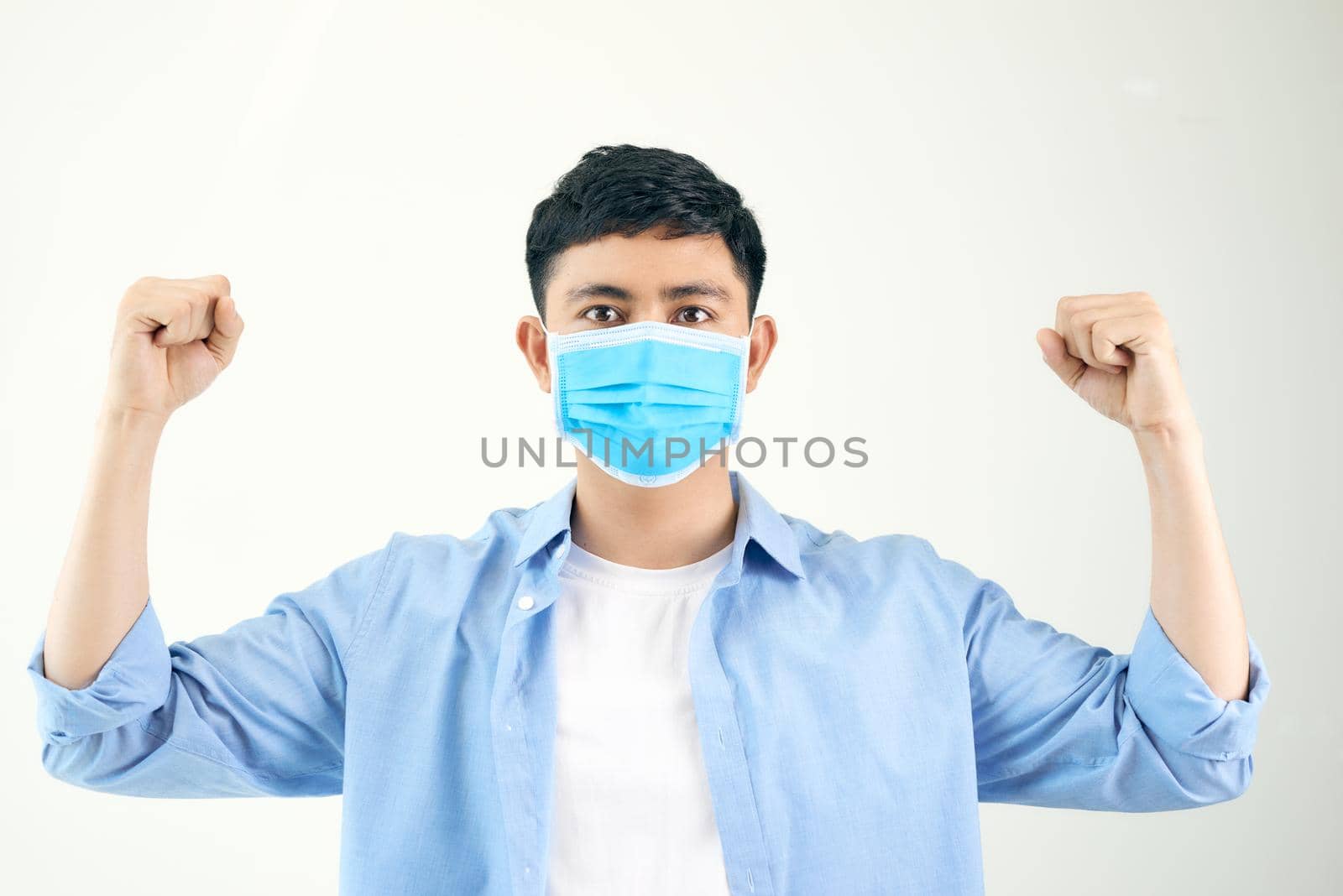 Young man rejoicing his success and victory clenching his fists with joy.