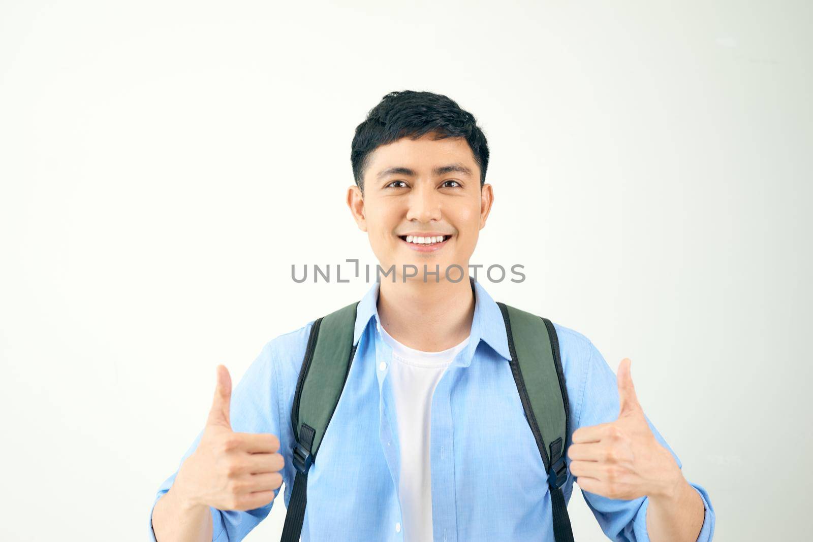 Young man giving two thumbs up isolated on white background by makidotvn