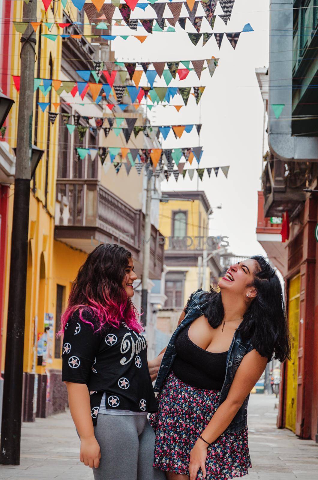 Portrait of beautiful chubby caucasian women in the street smiling to the camera