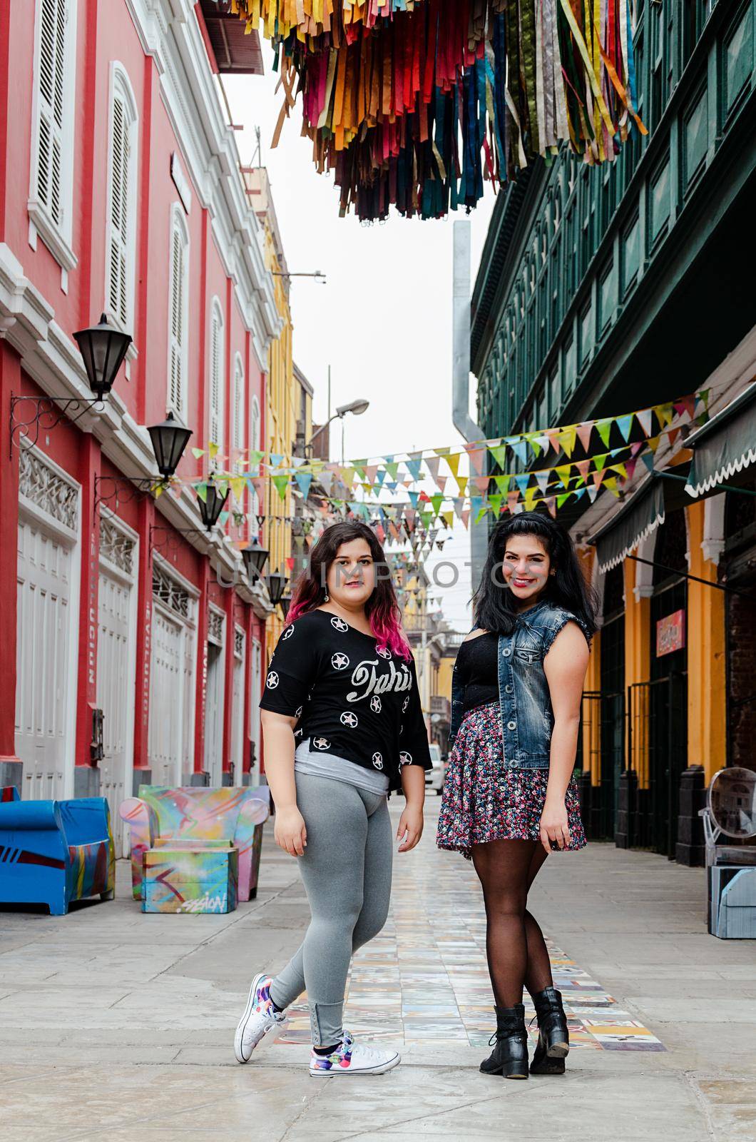 Portrait of beautiful chubby caucasian women in the street smiling to the camera