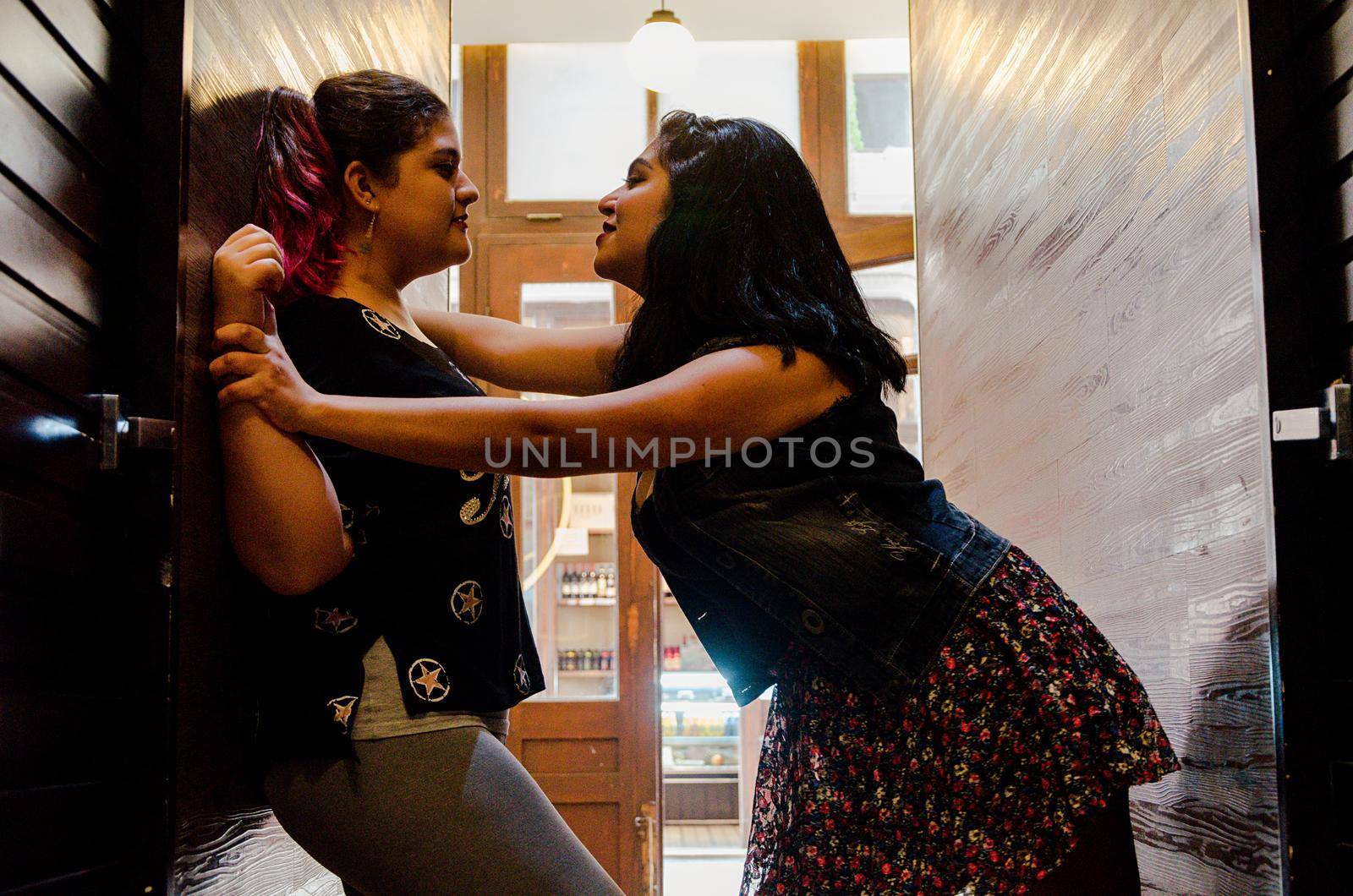 Two lesbian women stroking each other strongly, concept of love between people of the same sex by Peruphotoart
