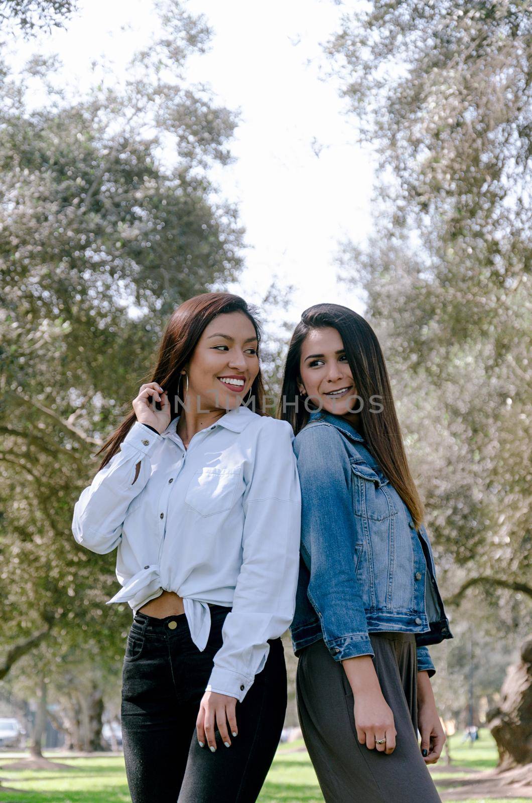 Two women best friends over park background a day of autumn by Peruphotoart