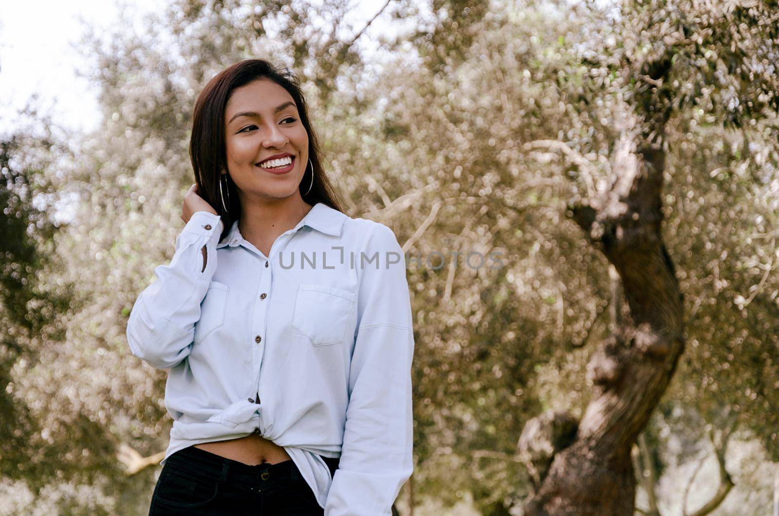 Fine art soft warm colors portrait of young smiling tender innocent teenager girl with kind lovely face.