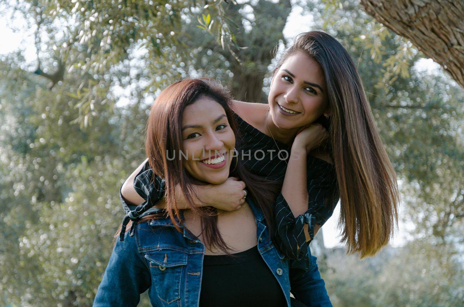 Outdoor lifestyle portrait of two best friends, smiling and having fun together