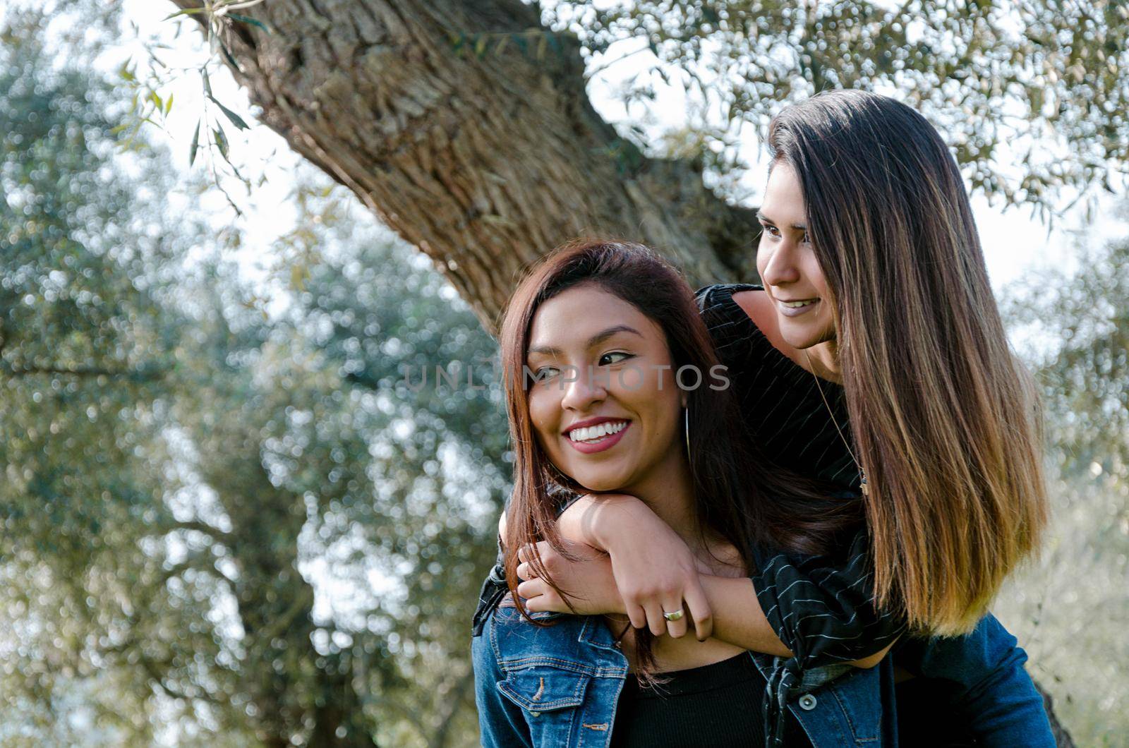 Outdoor lifestyle portrait of two best friends, smiling and having fun together