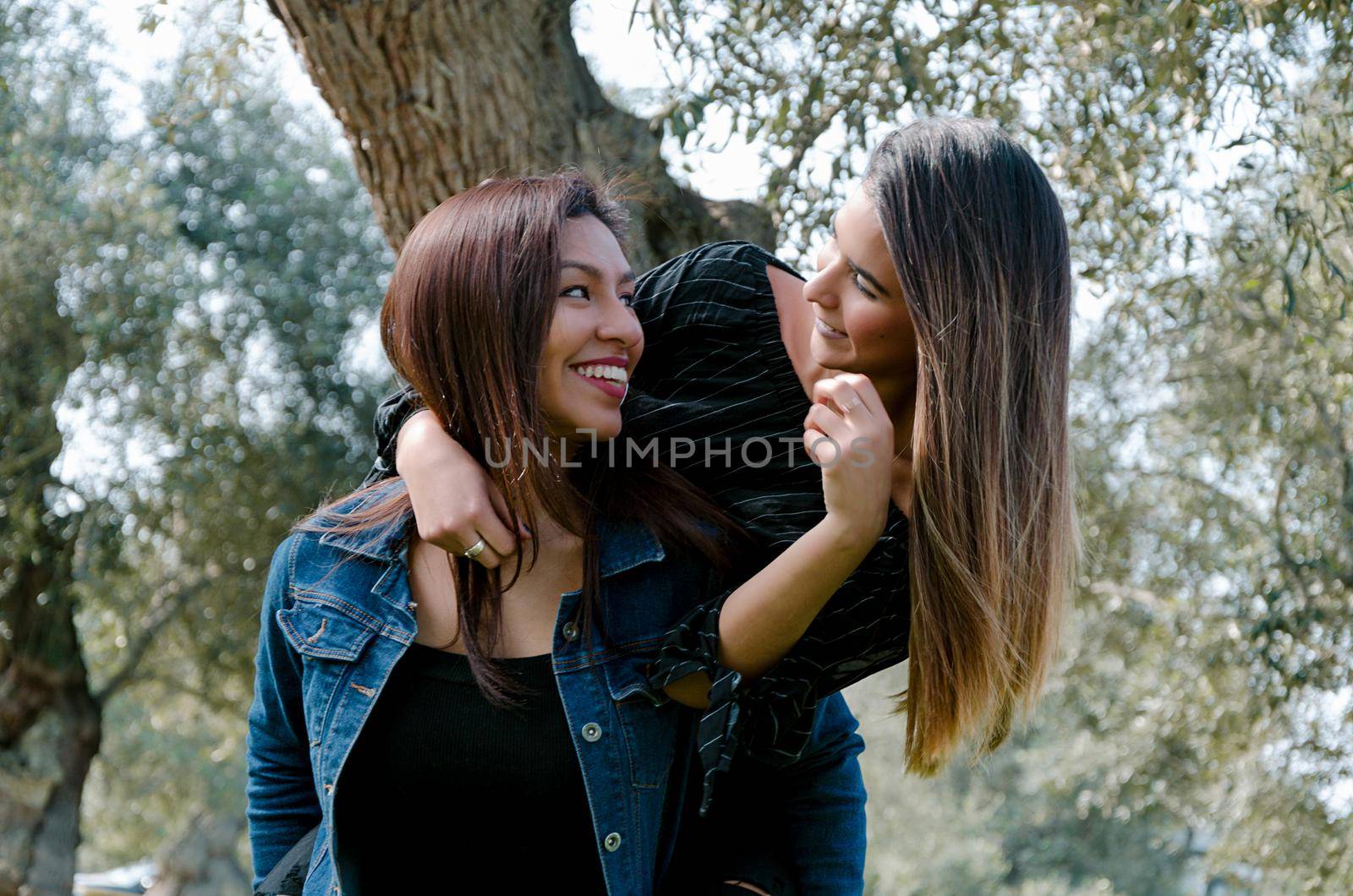 Outdoor lifestyle portrait of two best friends, smiling and having fun together