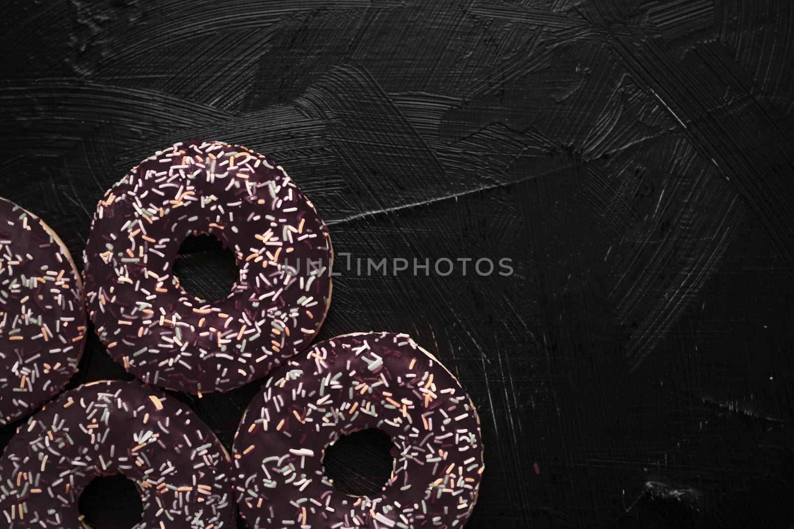 Bakery, branding and cafe concept - Frosted sprinkled donuts, sweet pastry dessert on rustic wooden background, doughnuts as tasty snack, top view food brand flat lay for blog, menu or cookbook design