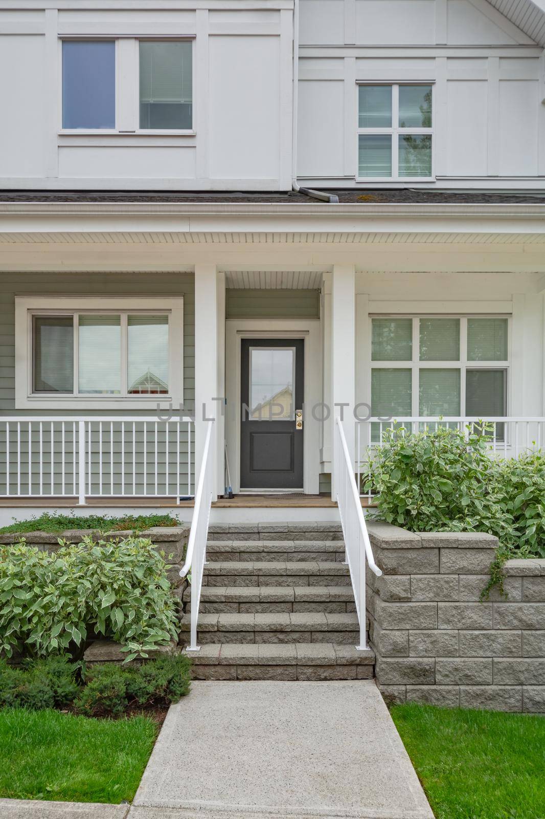 Entrance of residential unit under the porch with doorsteps in front.