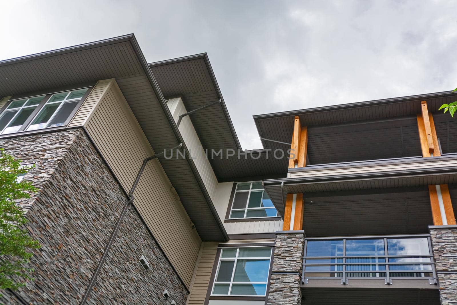 Residential building roof silhouette on overcast sky background.