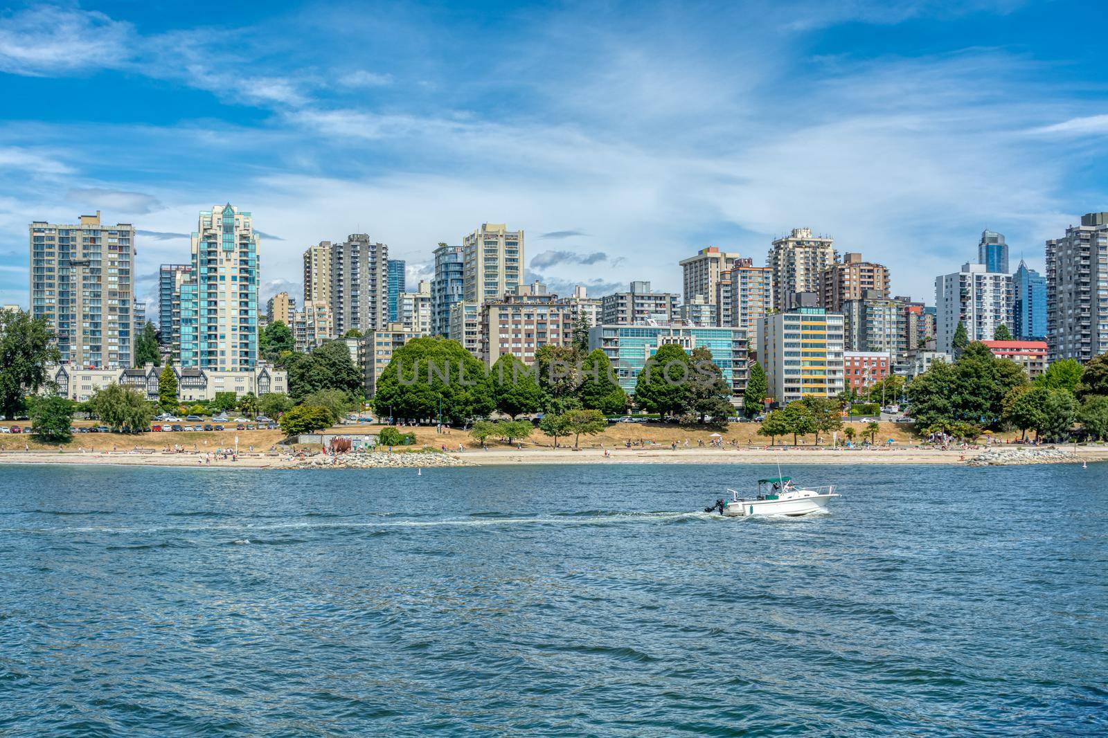 View on old part of Vancouver downtown over Coal harbor. Downtown view with mountains and cloudy sky on the background