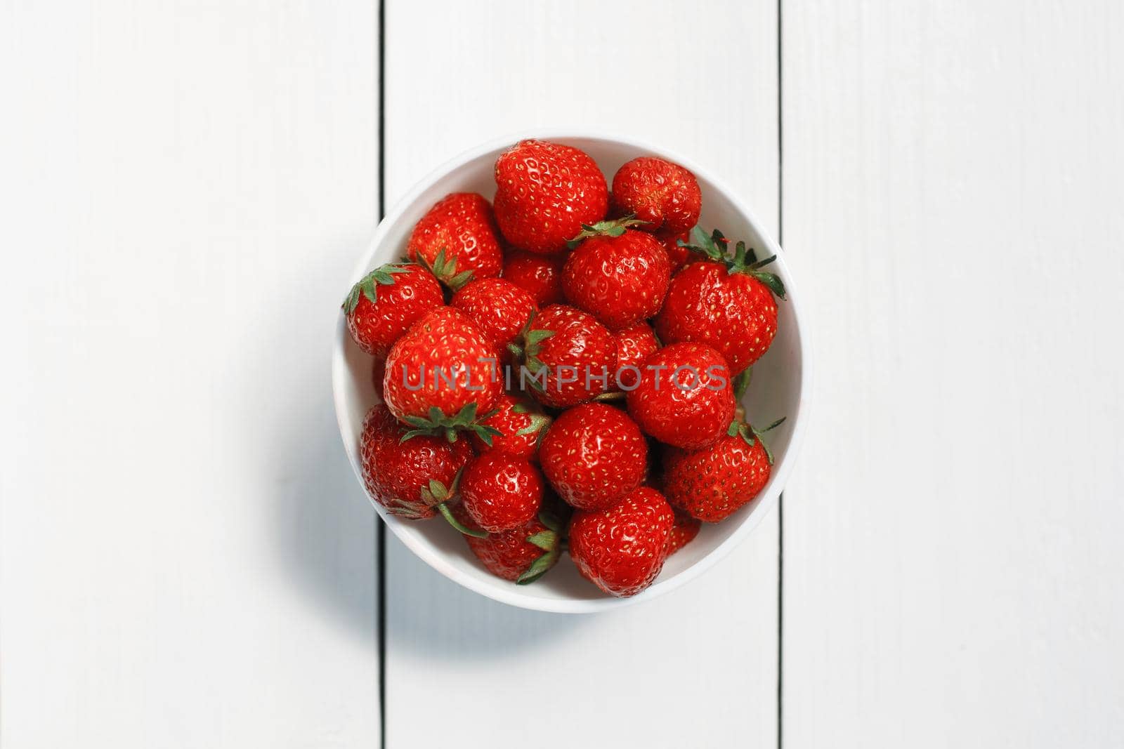 Bowl of strawberries top view by alones