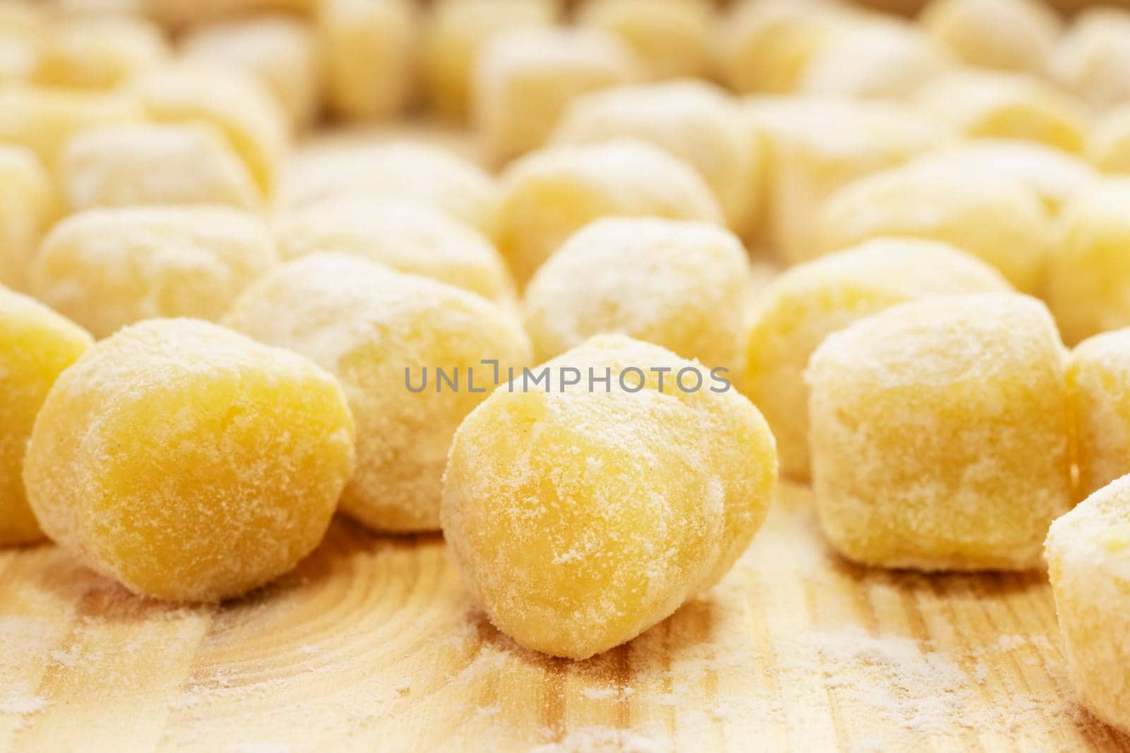 Raw gnocchi on  wooden board   , uncooked food with flour ready to be cooked