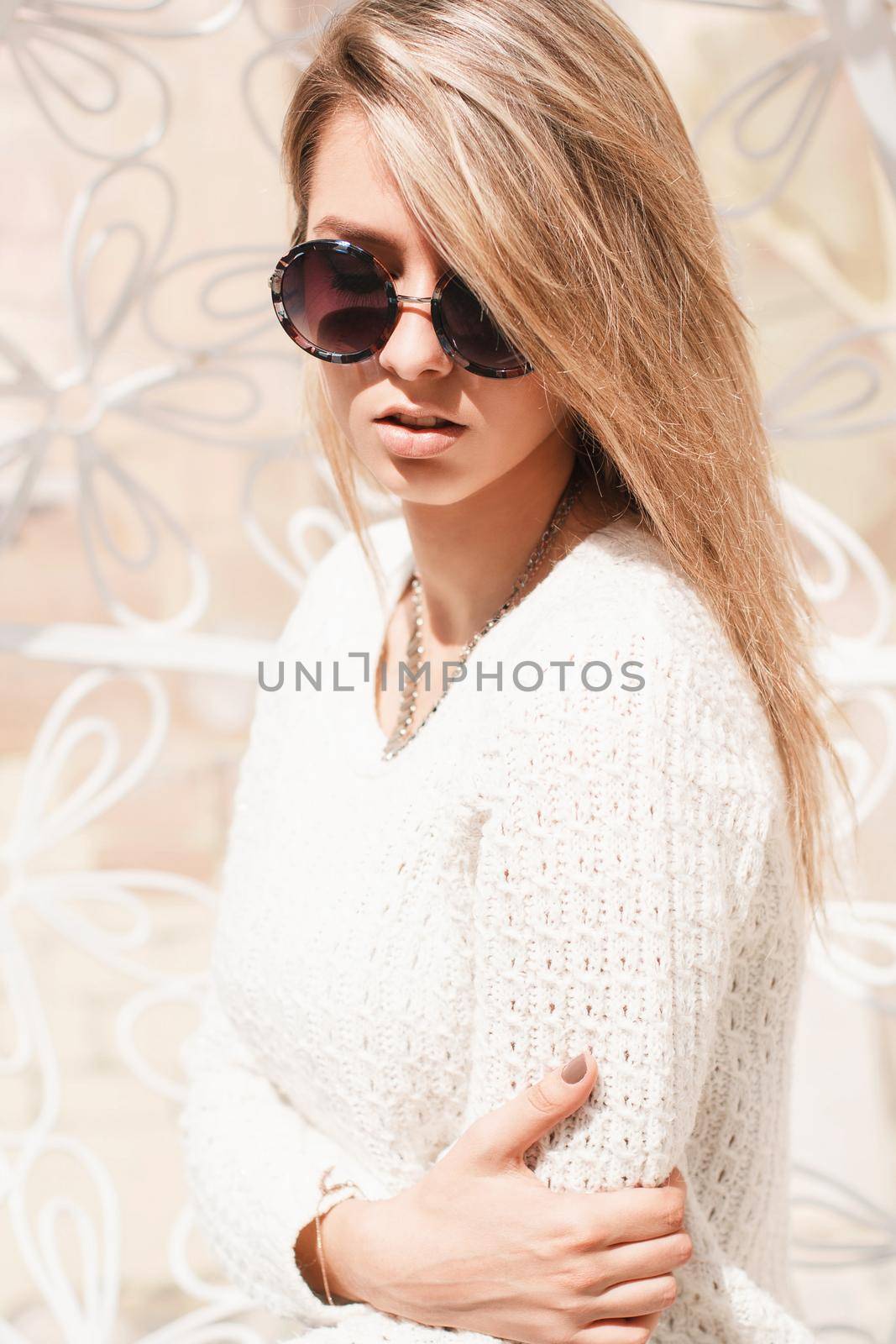 Outdoor fashion portrait of young pretty woman with round sunglasses in summer sunny day on street. by alones