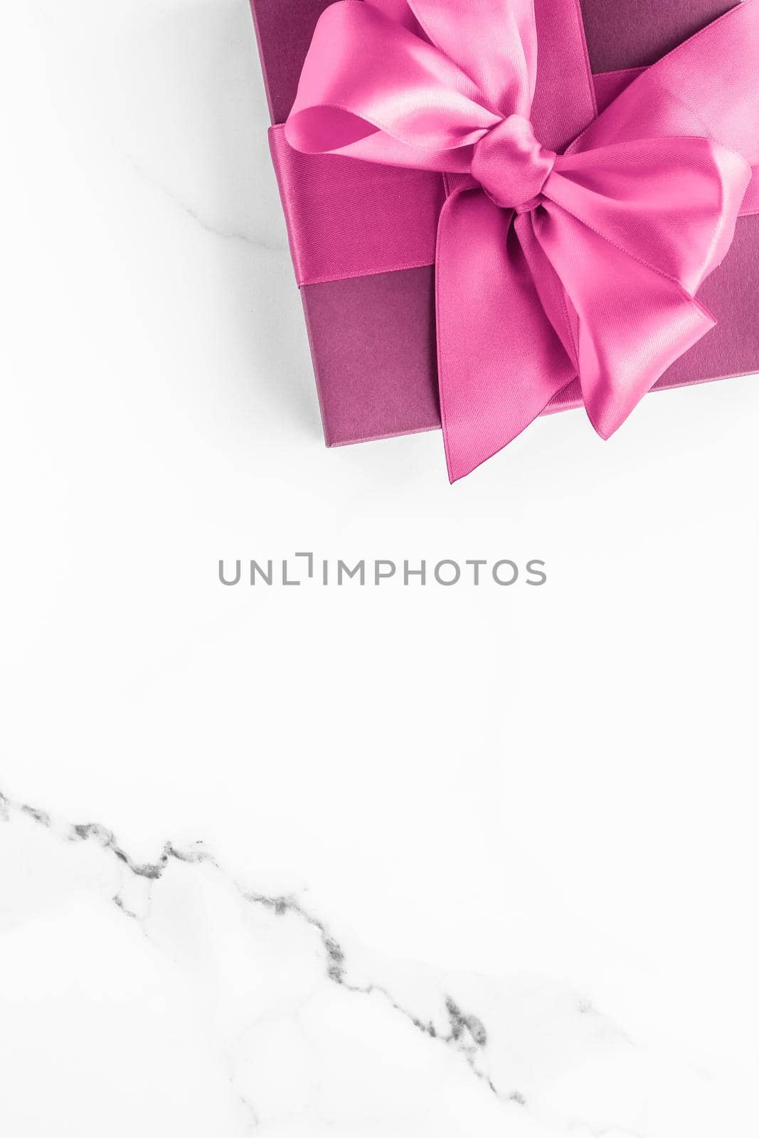 Birthday, wedding and girly branding concept - Pink gift box with silk bow on marble background, girl baby shower present and glamour fashion gift for luxury beauty brand, holiday flatlay art design