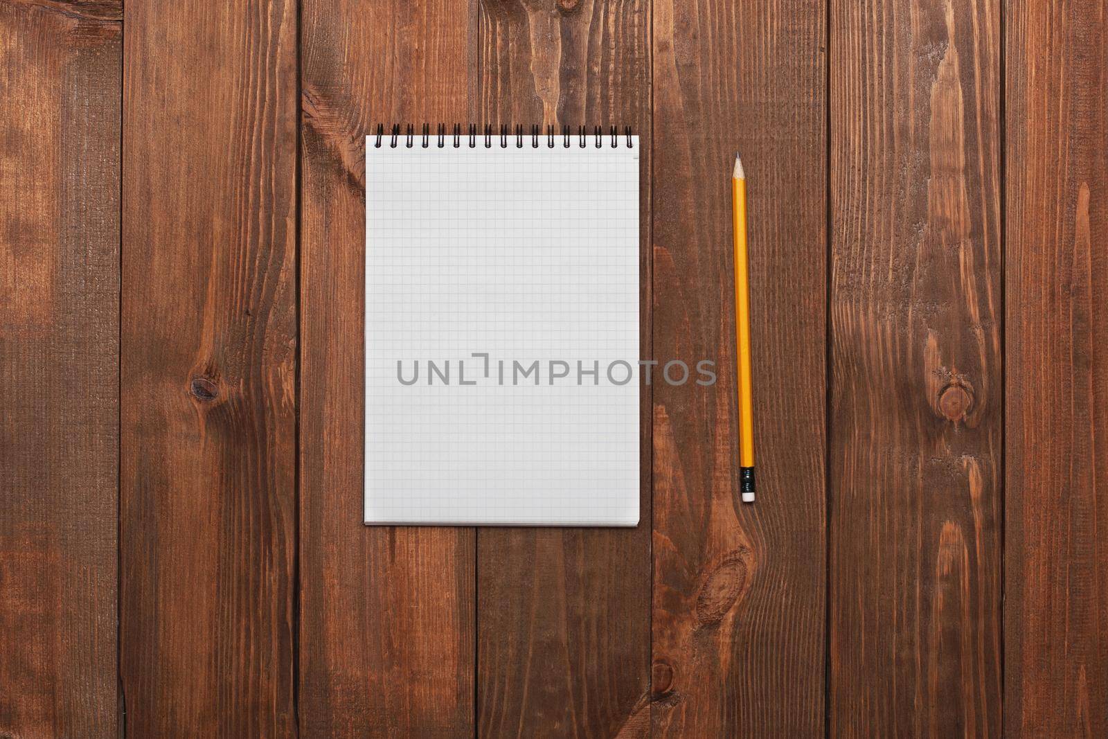 Notebook with a pencil on the table