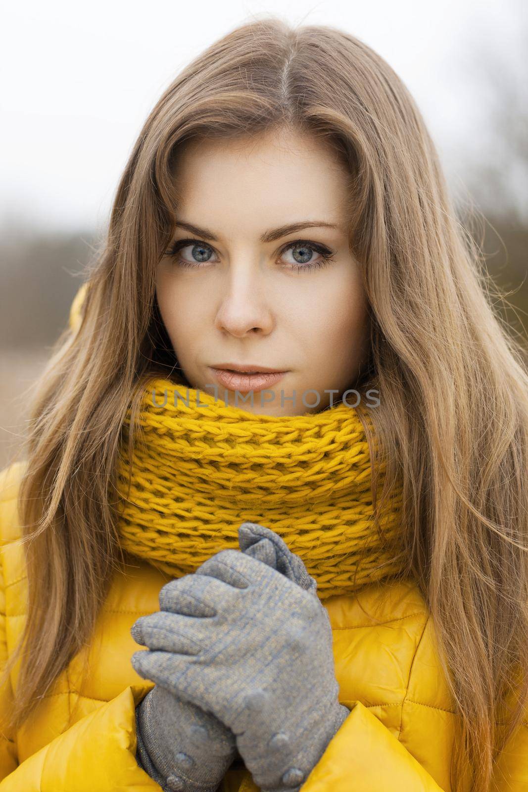 Pretty woman in a yellow knit scarf. ?ool weather. by alones