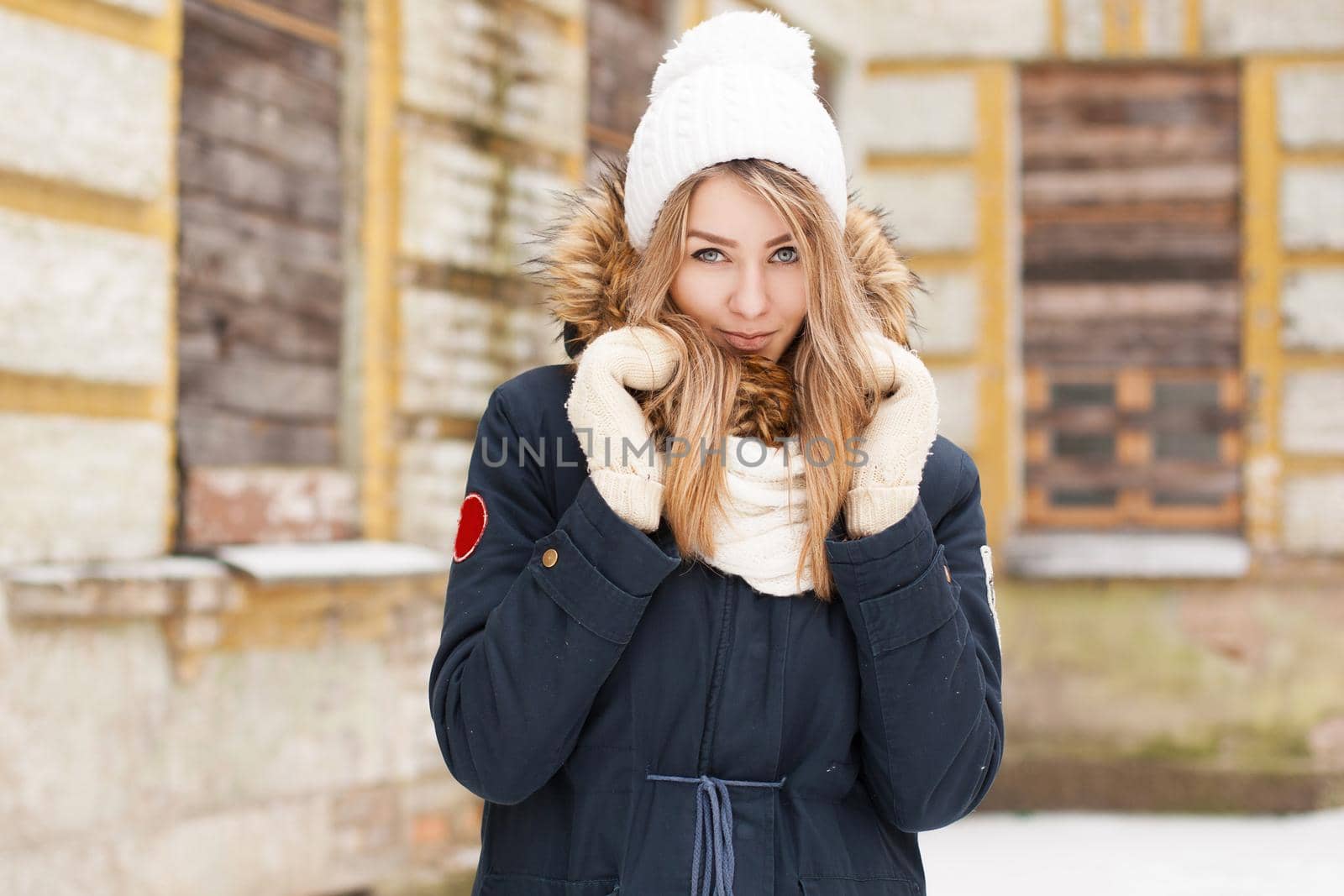 Beautiful girl hiding in knitted scarf. Outdoors portrait. by alones