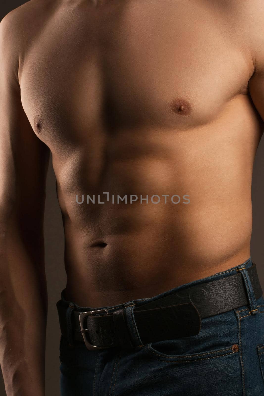 Body of a man in the studio. Relief abdominal muscles.  by alones
