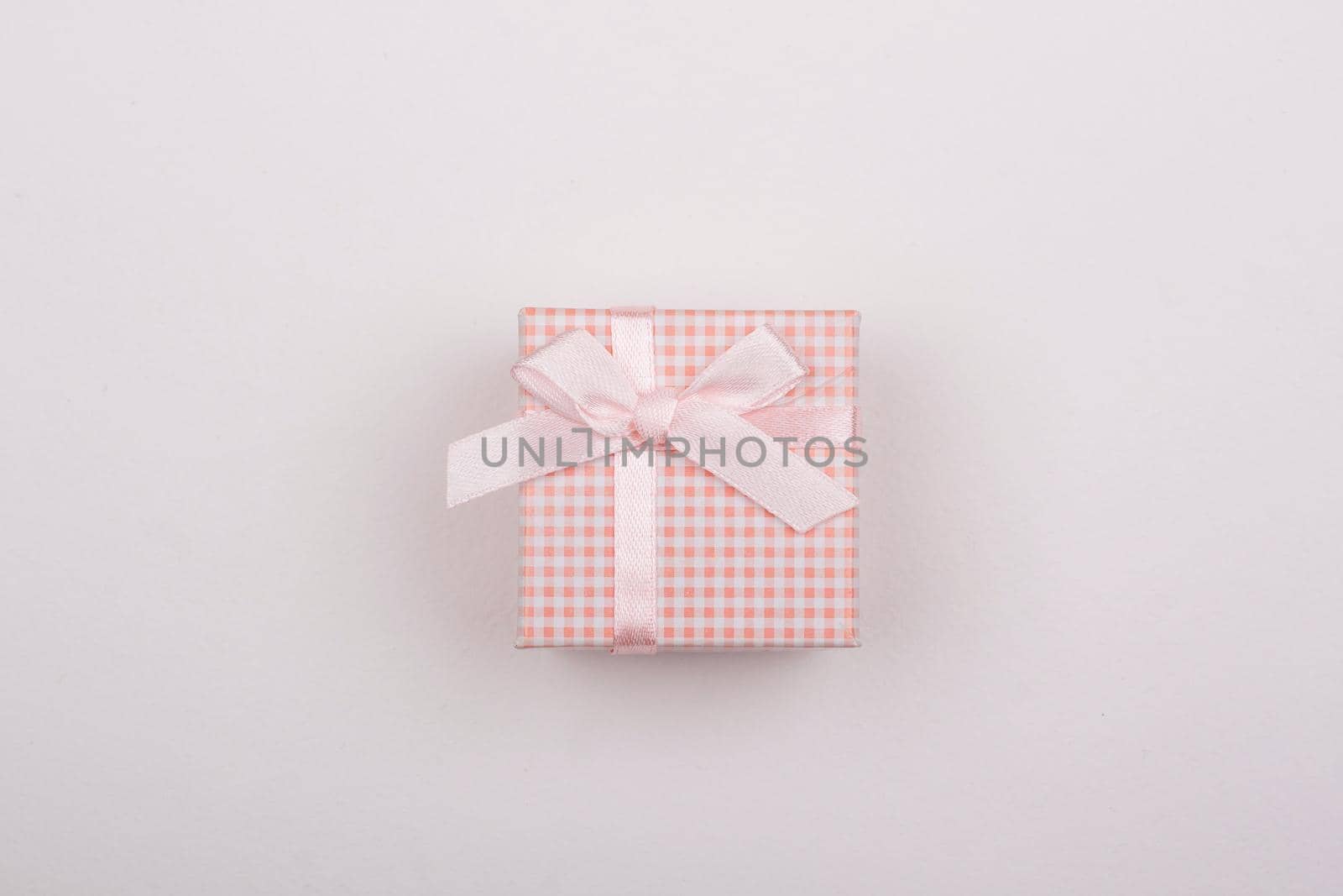 Pink gift with bow on a white background.