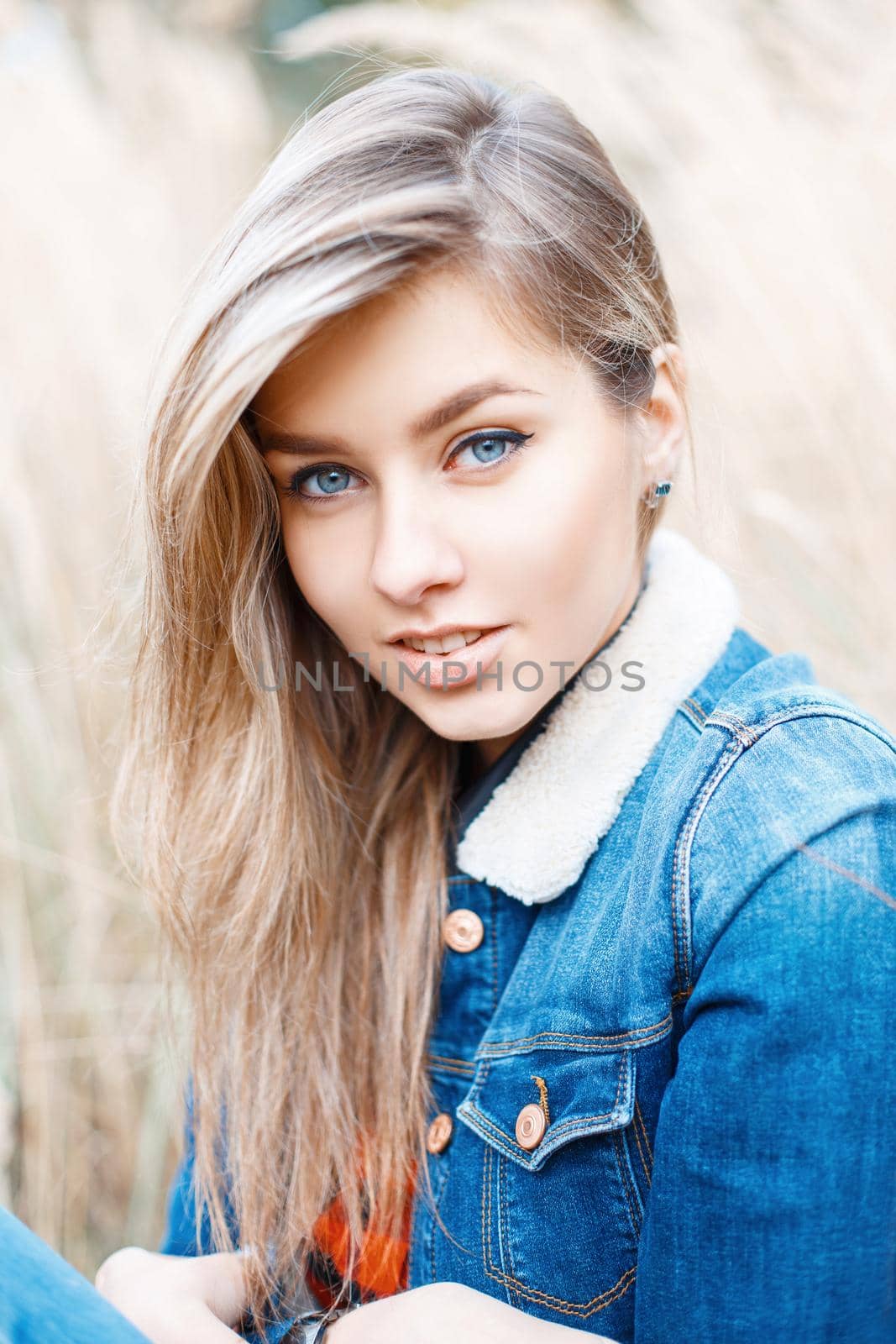 Cute girl smiling in jeans jacket with fur.