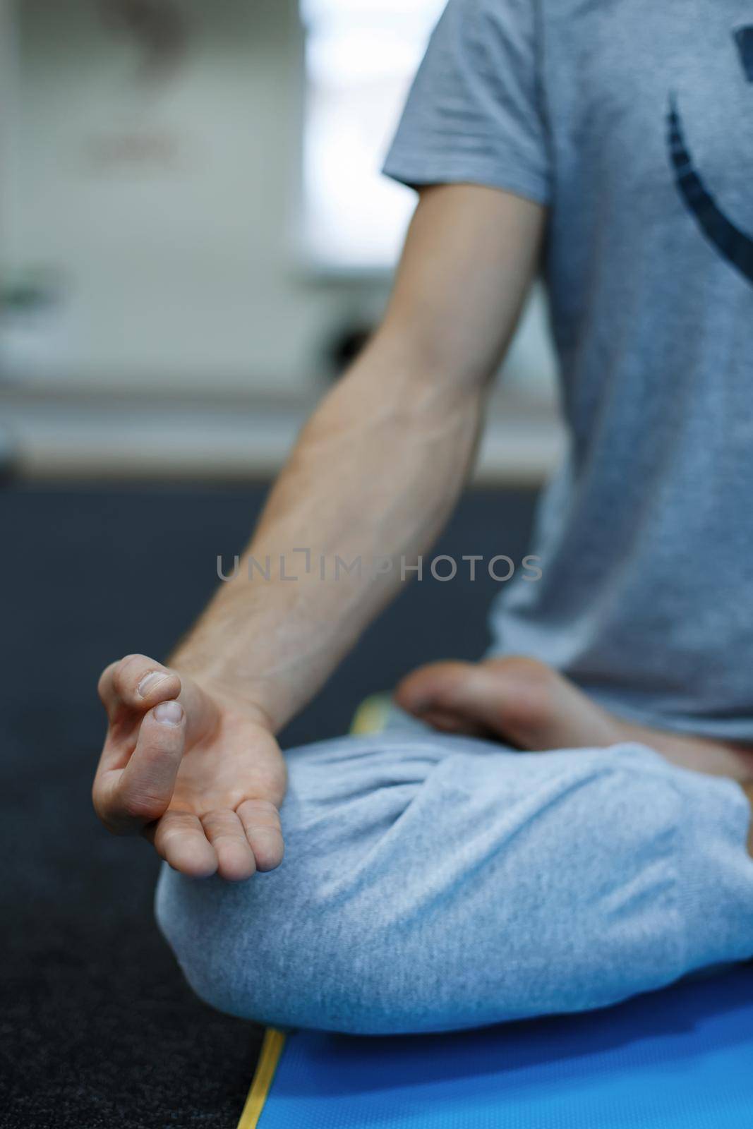 Young man doing yoga by alones