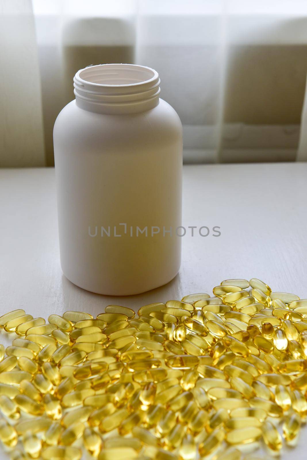 Fish oil capsules with omega 3 and vitamin D in a bottle on wooden texture, healthy diet concept,close up shot.