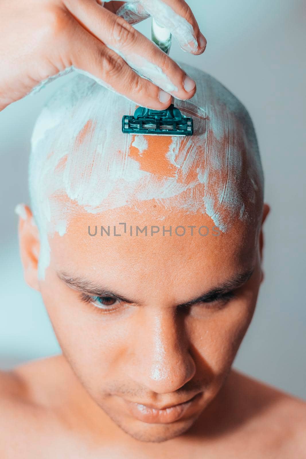 Man Shaving His Head Using White Foam