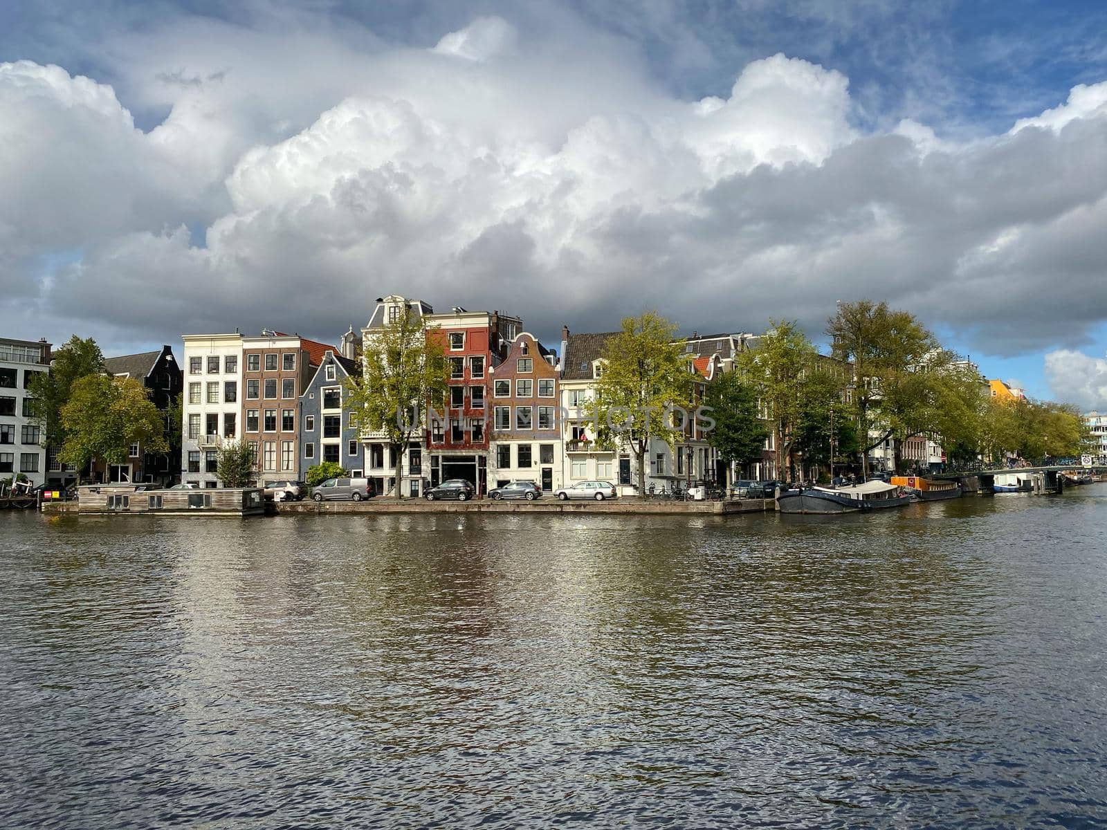 Amsterdam canal with typical dutch houses and houseboats, boats etc. by CaptureLight