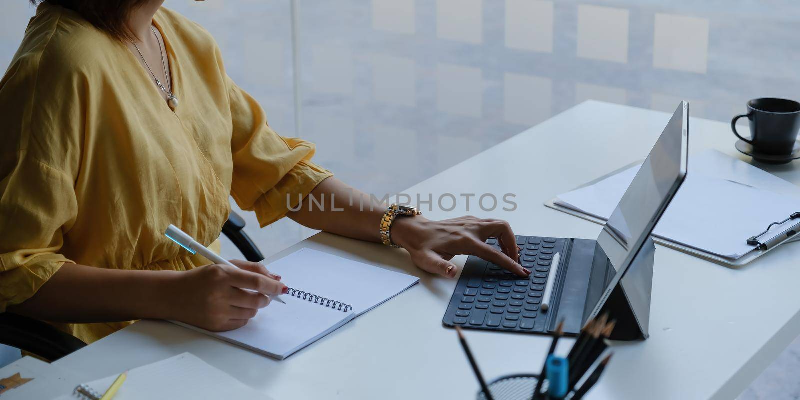Asian Business woman working with tablet in office. Work from home concept