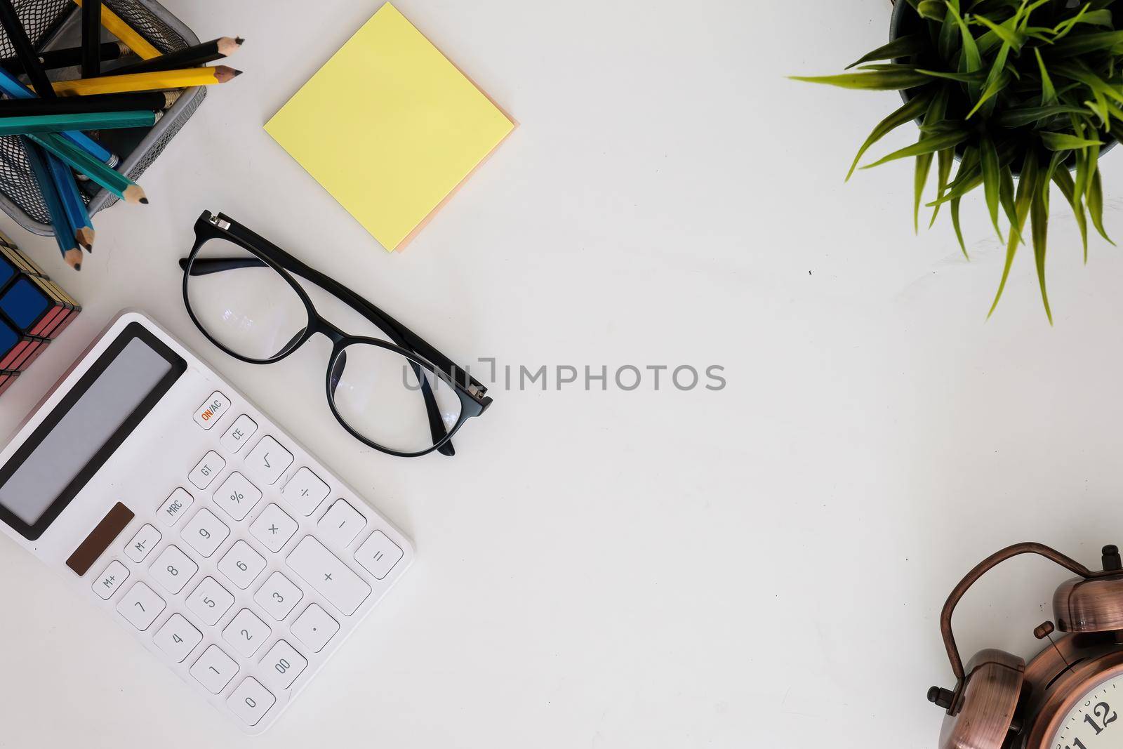 Modern white wooden desk table calculator and business tools office. top view by itchaznong