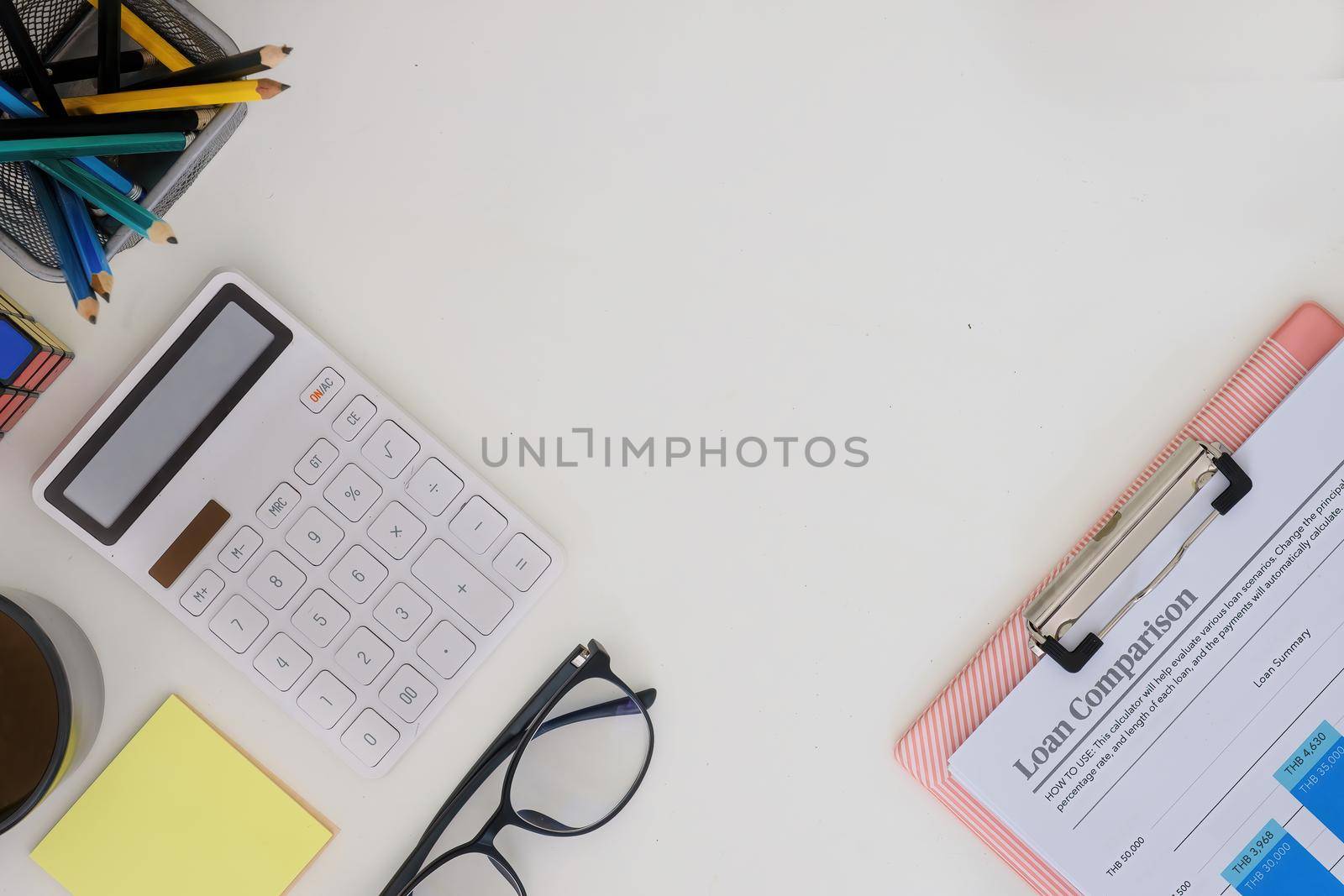 Calculator and paperwork on modern white wooden desk in accountant office. business financial, tax concept.