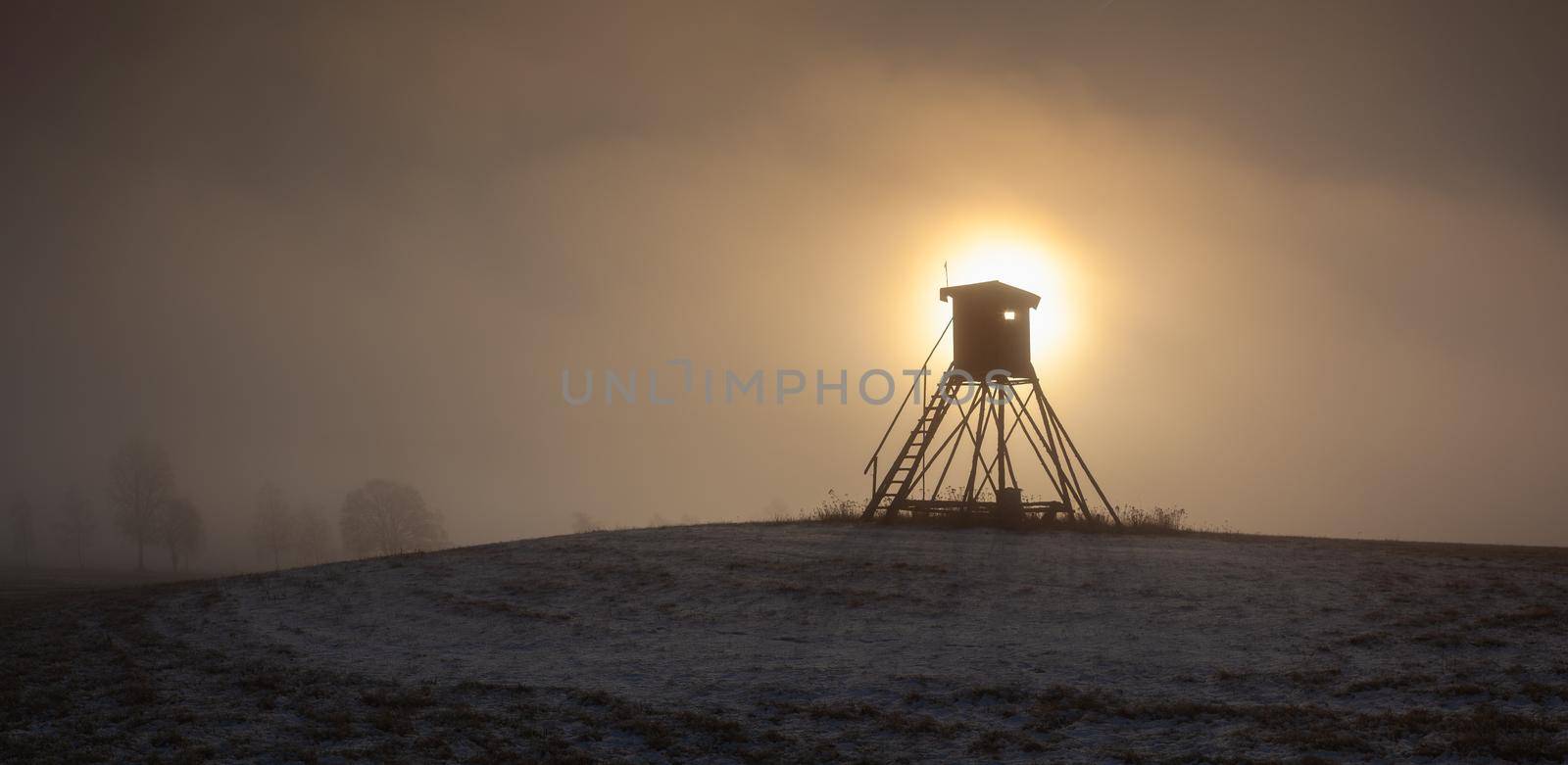 Lookout tower for hunting on the hill at sunrise.  by CaptureLight