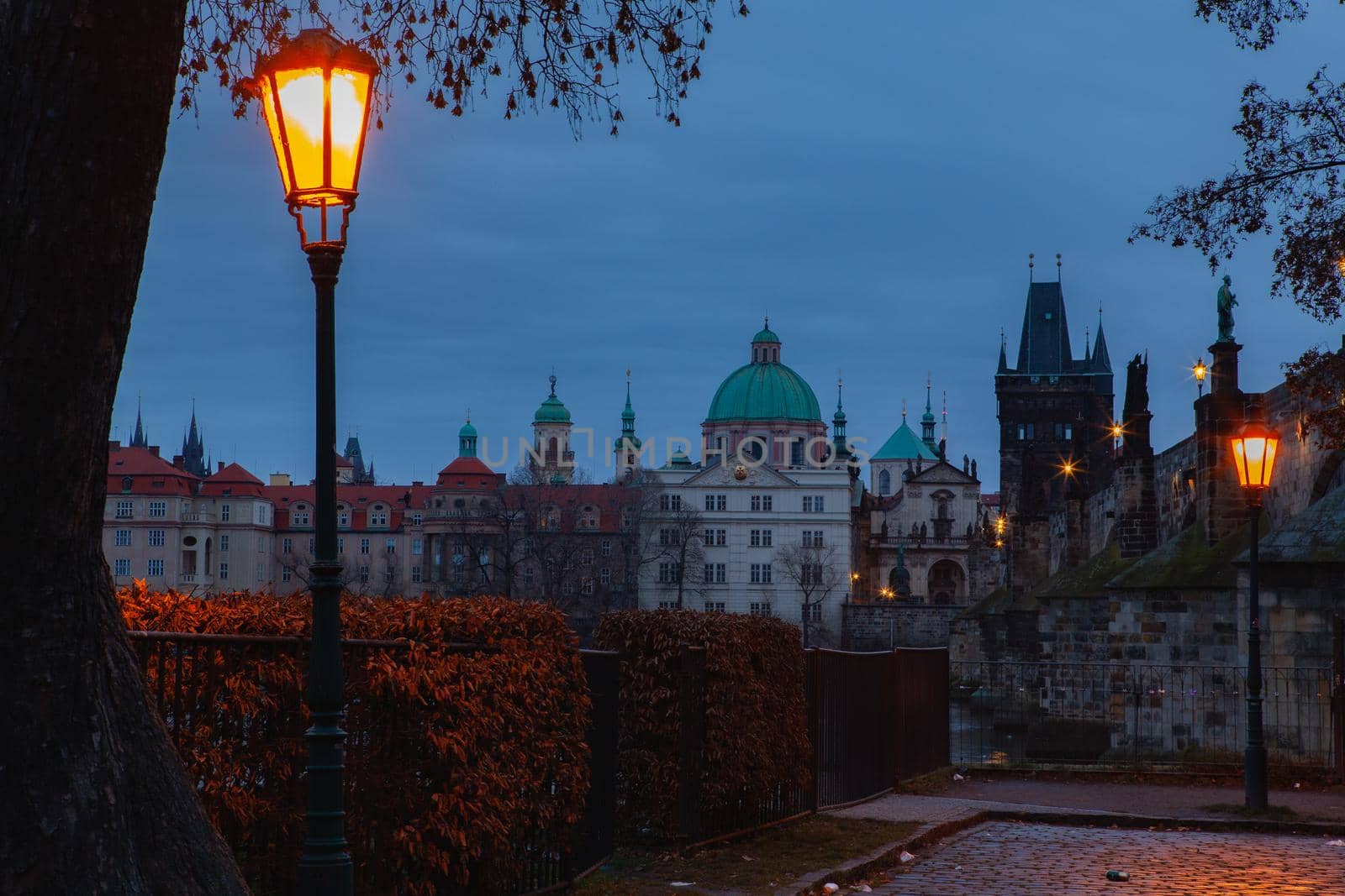 Evening scenery next to Charles bridge, Prague, Czech Republic. Twilight scenery. Popular European travel destination.