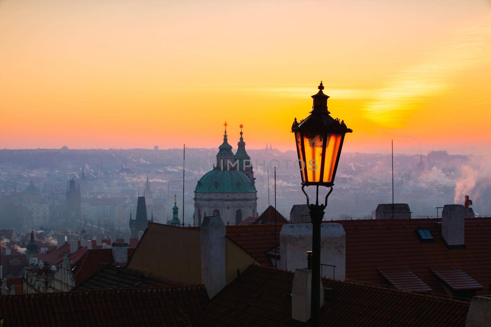 Sunrise behind an old street lamp over Lesser Town, Prague, Czech Republic.  by CaptureLight