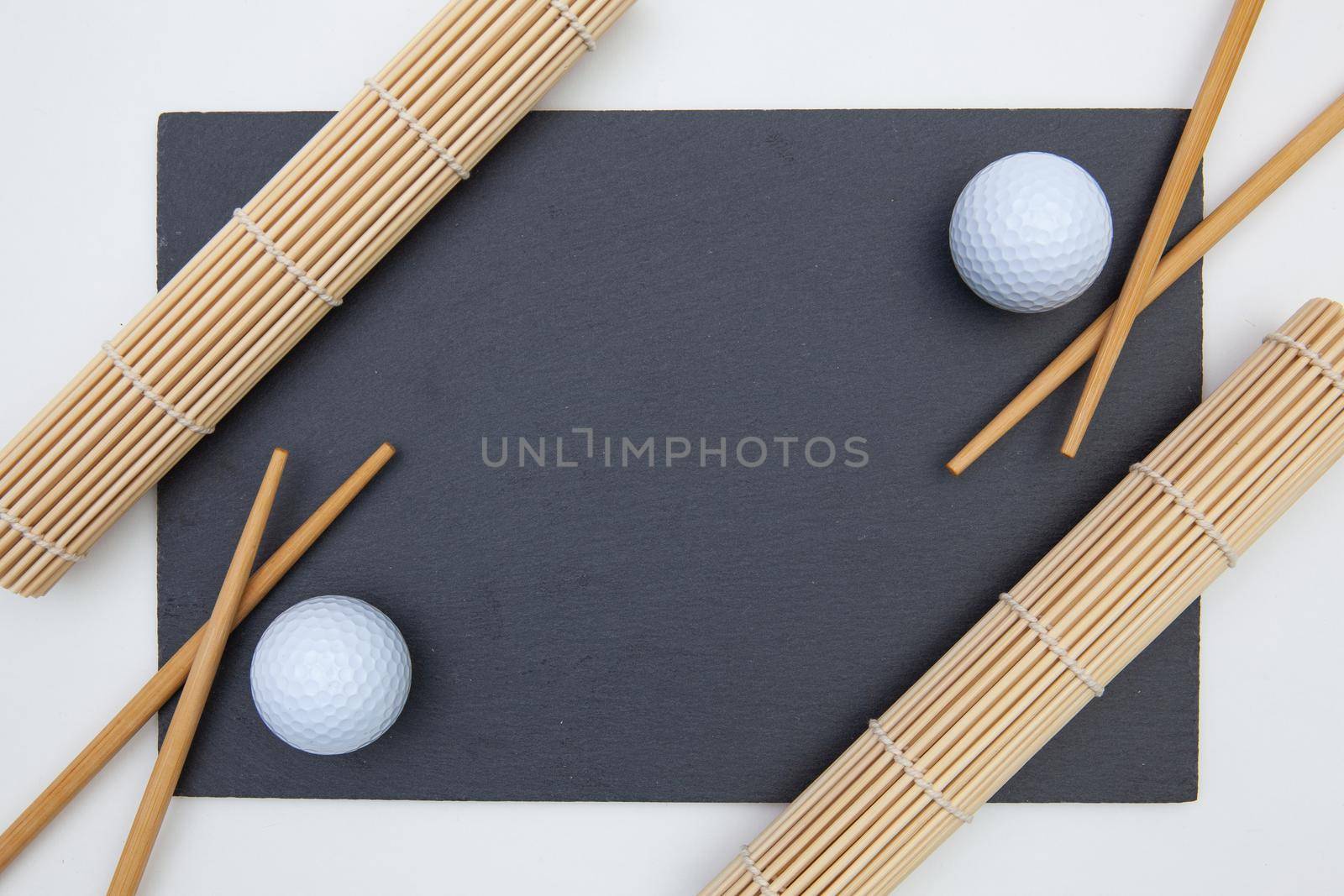 Rectangular slate plate with chopsticks for sushi and golf ball. Golf Design