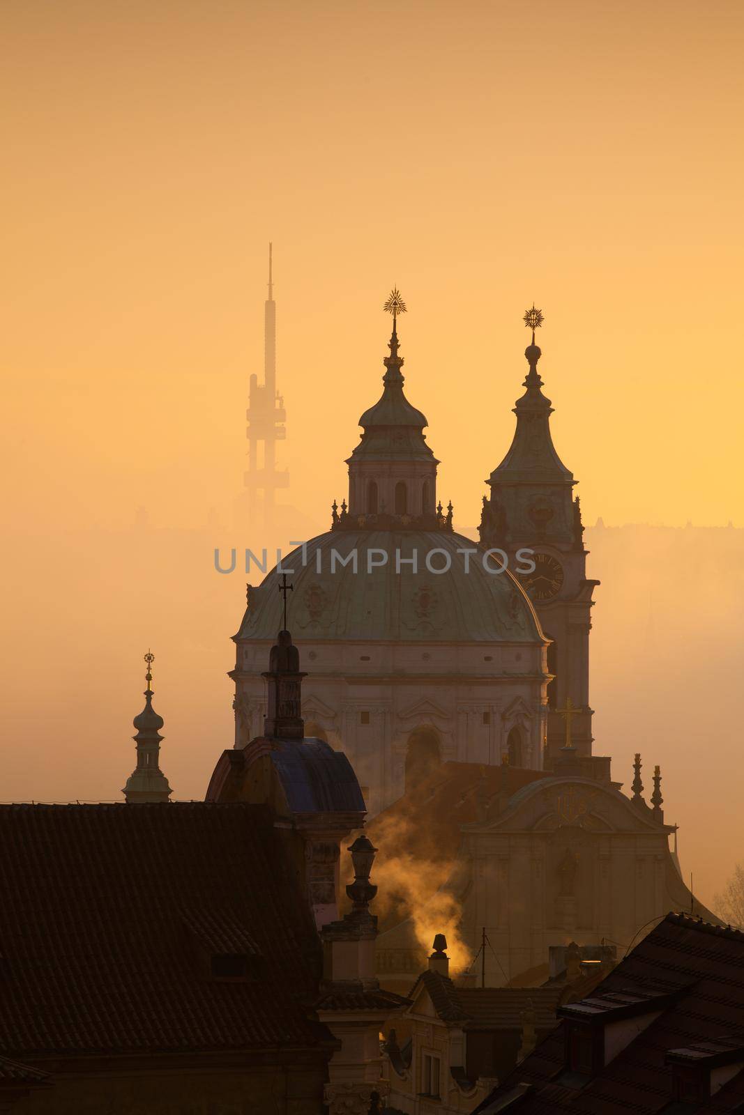 The Church of St.Nicholas in the mist. Prague, Czech Republic.This is the most famous Baroque church in Prague, stands along with the former Jesuit college in the centre of the Lesser Town Square.