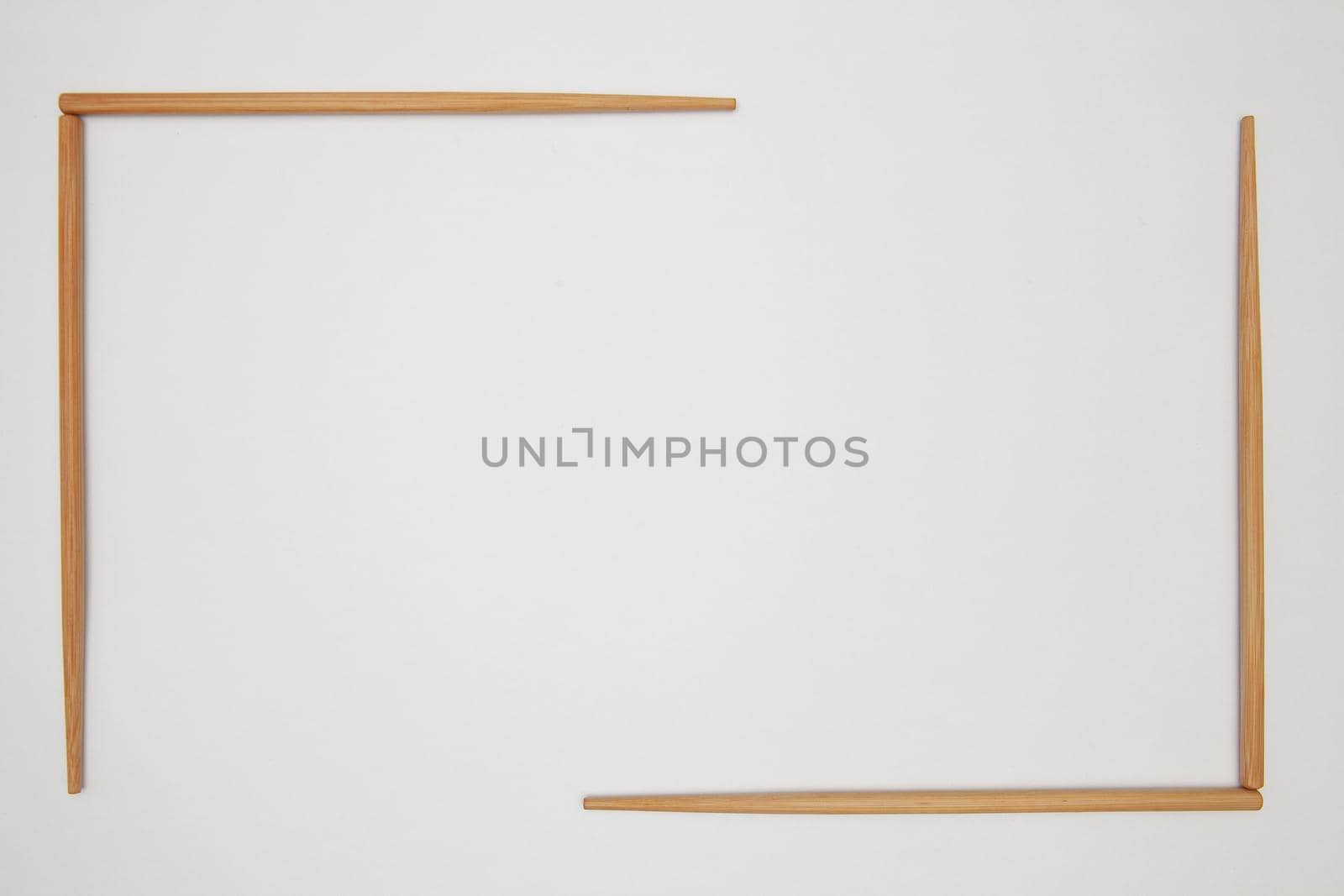 Top View On White Table With Bamboo Chopsticks. Symmetry Food Design