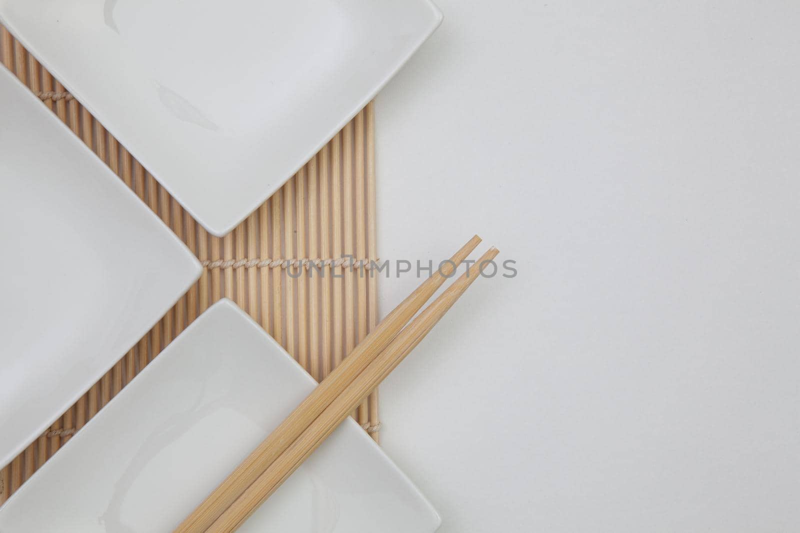 Top View Of White Empty Sushi Plates With Bamboo Chopsticks. Food Design