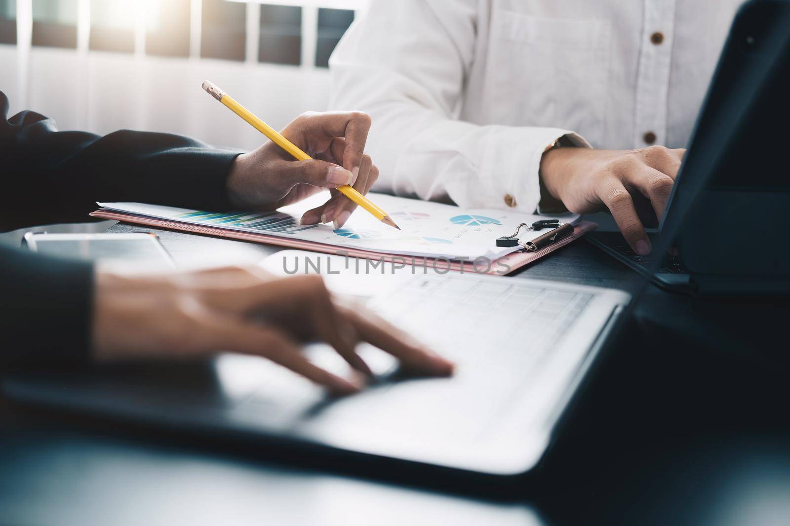 Business People Meeting to analyse and discuss and brainstorming the financial report chart data in office Financial advisor teamwork concept.