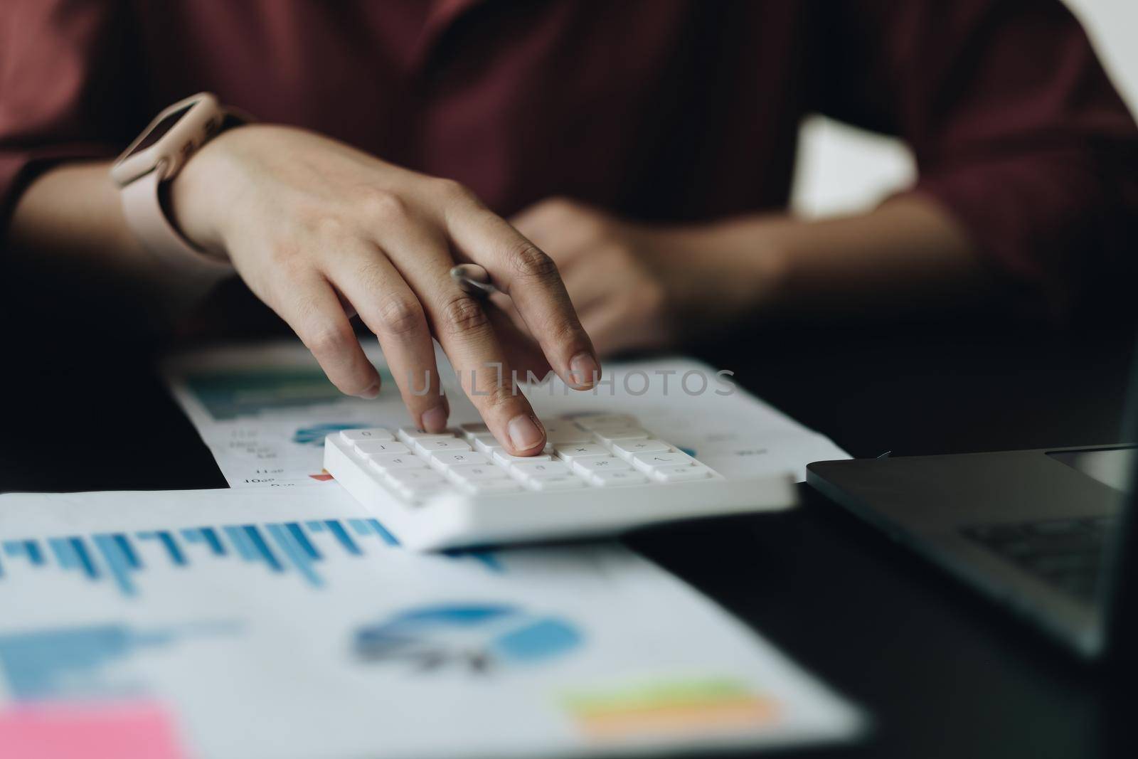 Close up a woman working about financial with calculator at his home to calculate expenses, Accounting concept