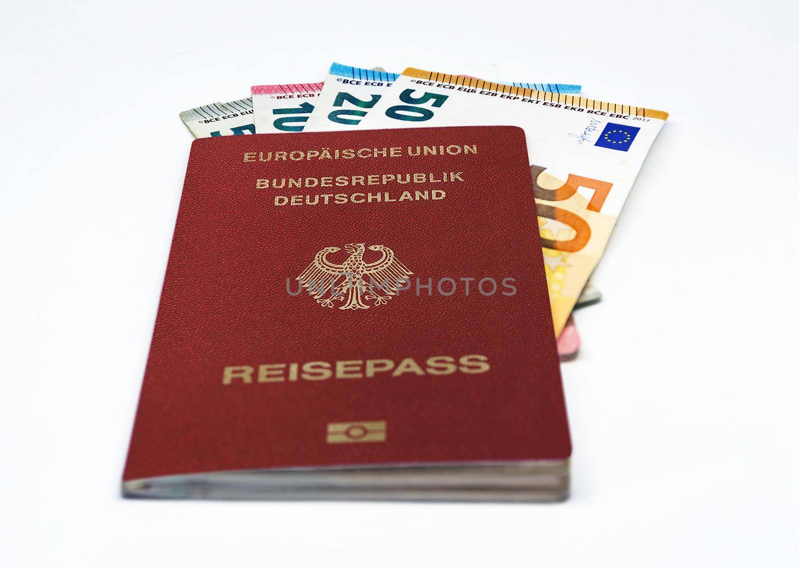 German travel passport with some euro banknotes isolated on a white background. European Union and single currency. Travel and cash