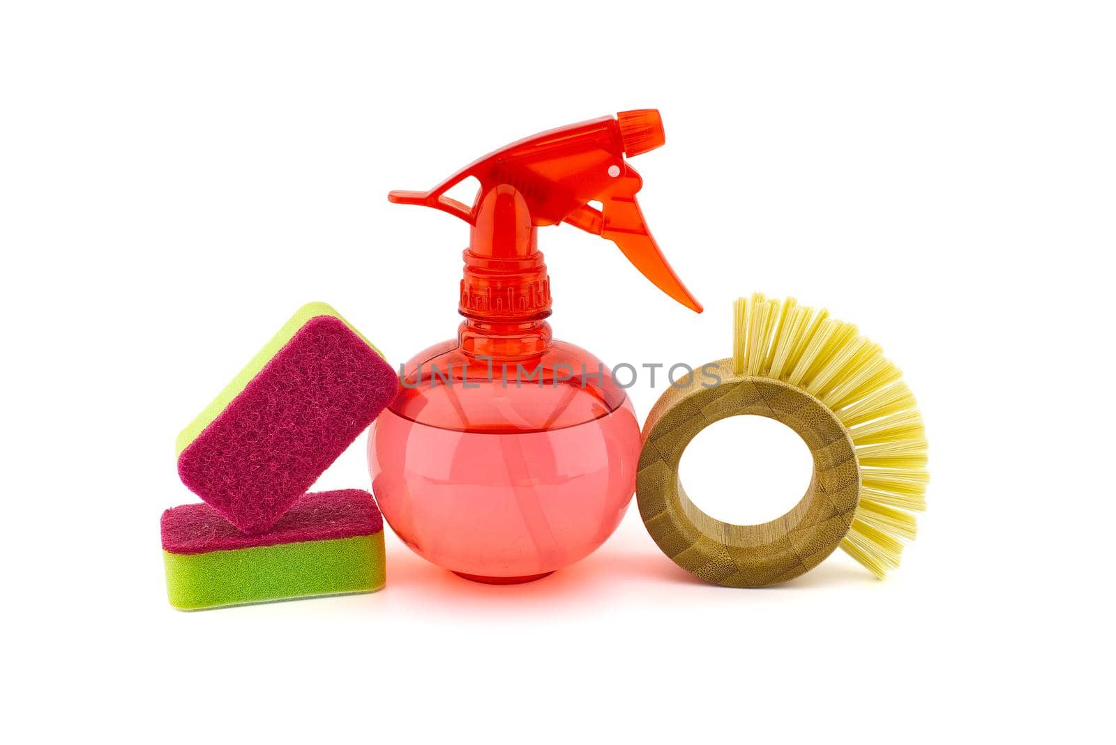 House cleaning supplies on white background including several sponges, dish brushes and spray bottle