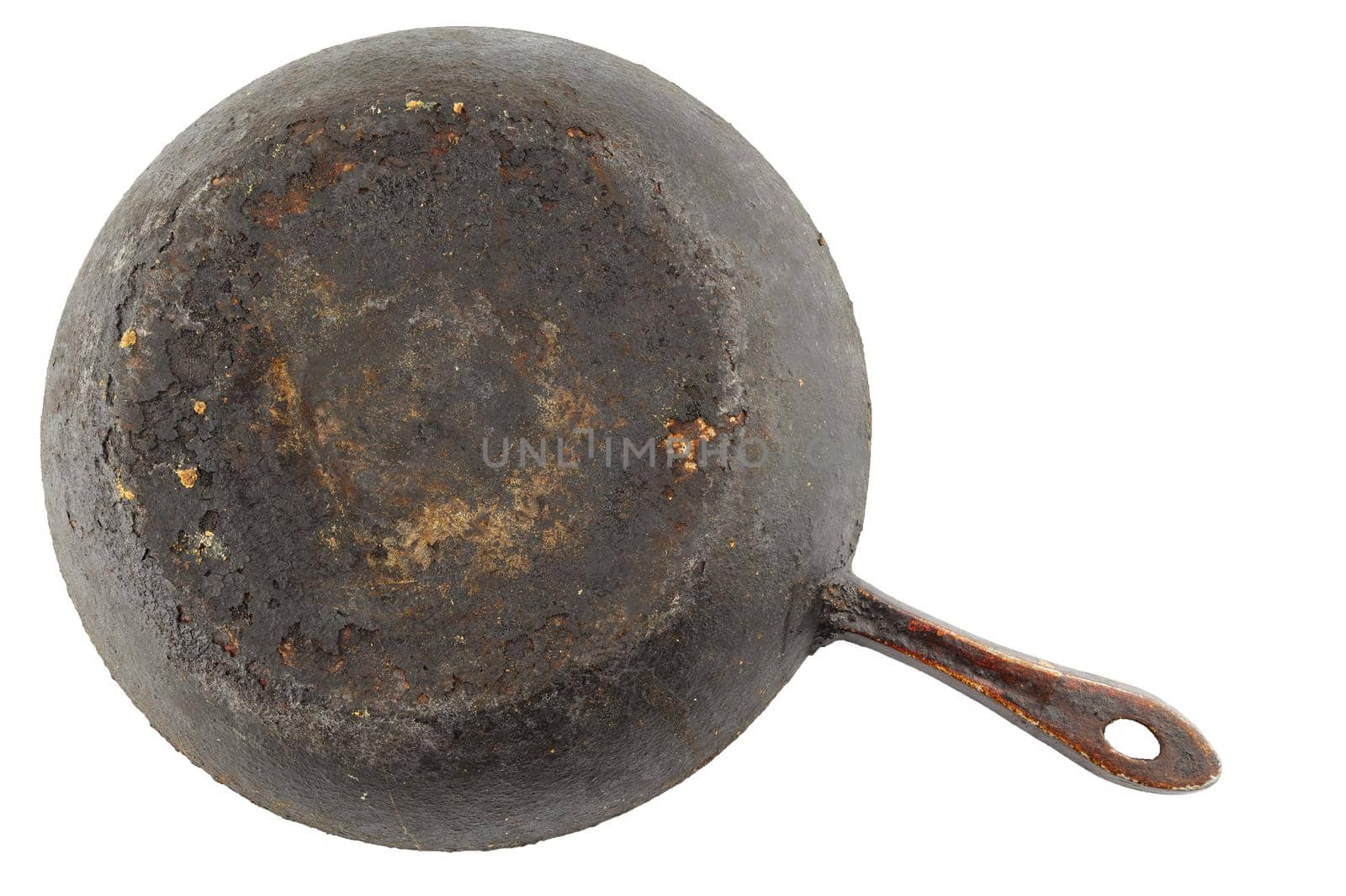 old stained rusty cast iron pan with burnt fat isolated on white bottom up in flat lay perspective.
